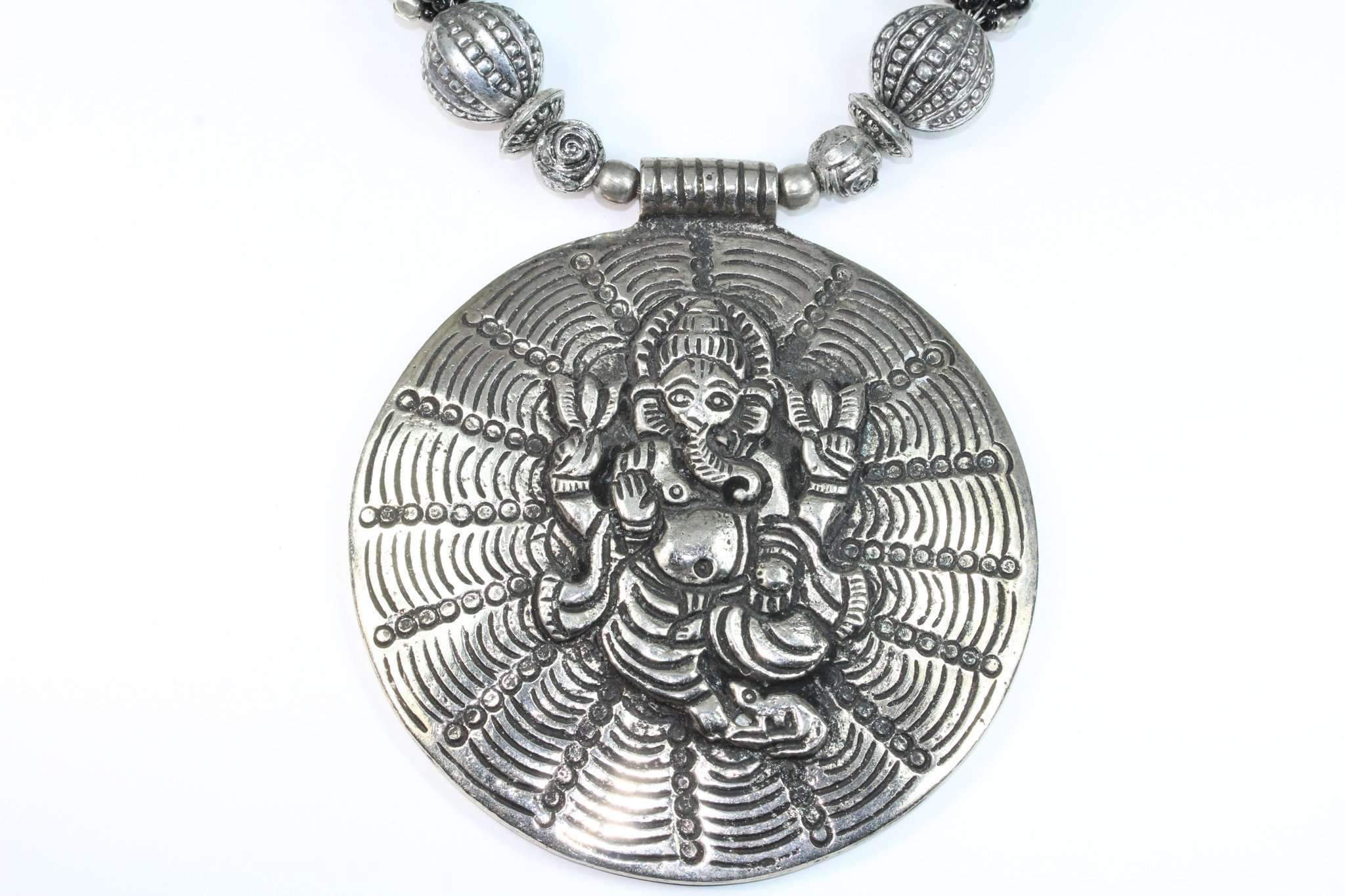 Handcrafted Ganesha in Cosmos Statement Necklace featuring black and silvertone beads with a large Ganesha pendant.