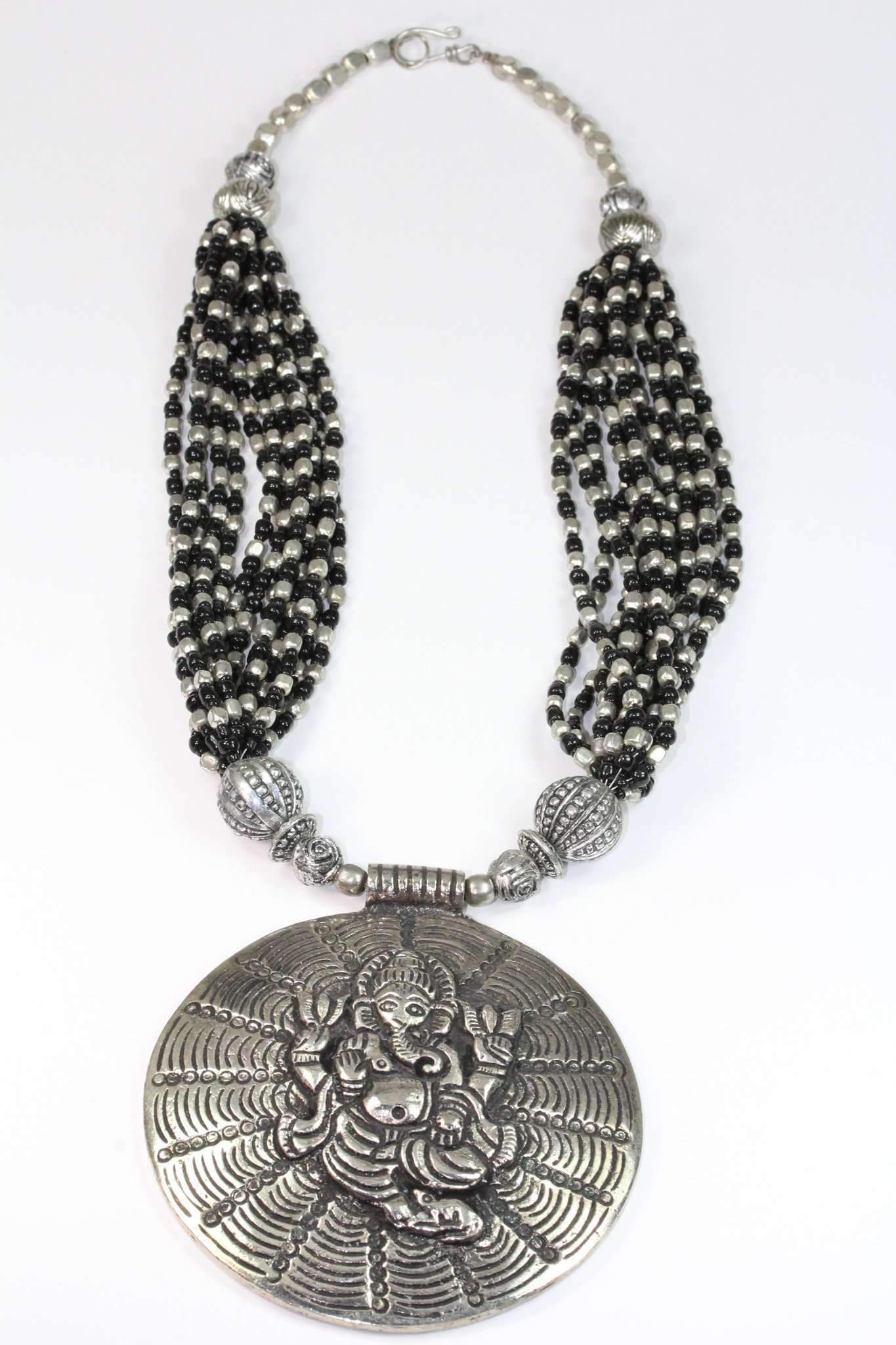 Handcrafted Ganesha in Cosmos Statement Necklace featuring black and silvertone beads with a large Ganesha pendant.