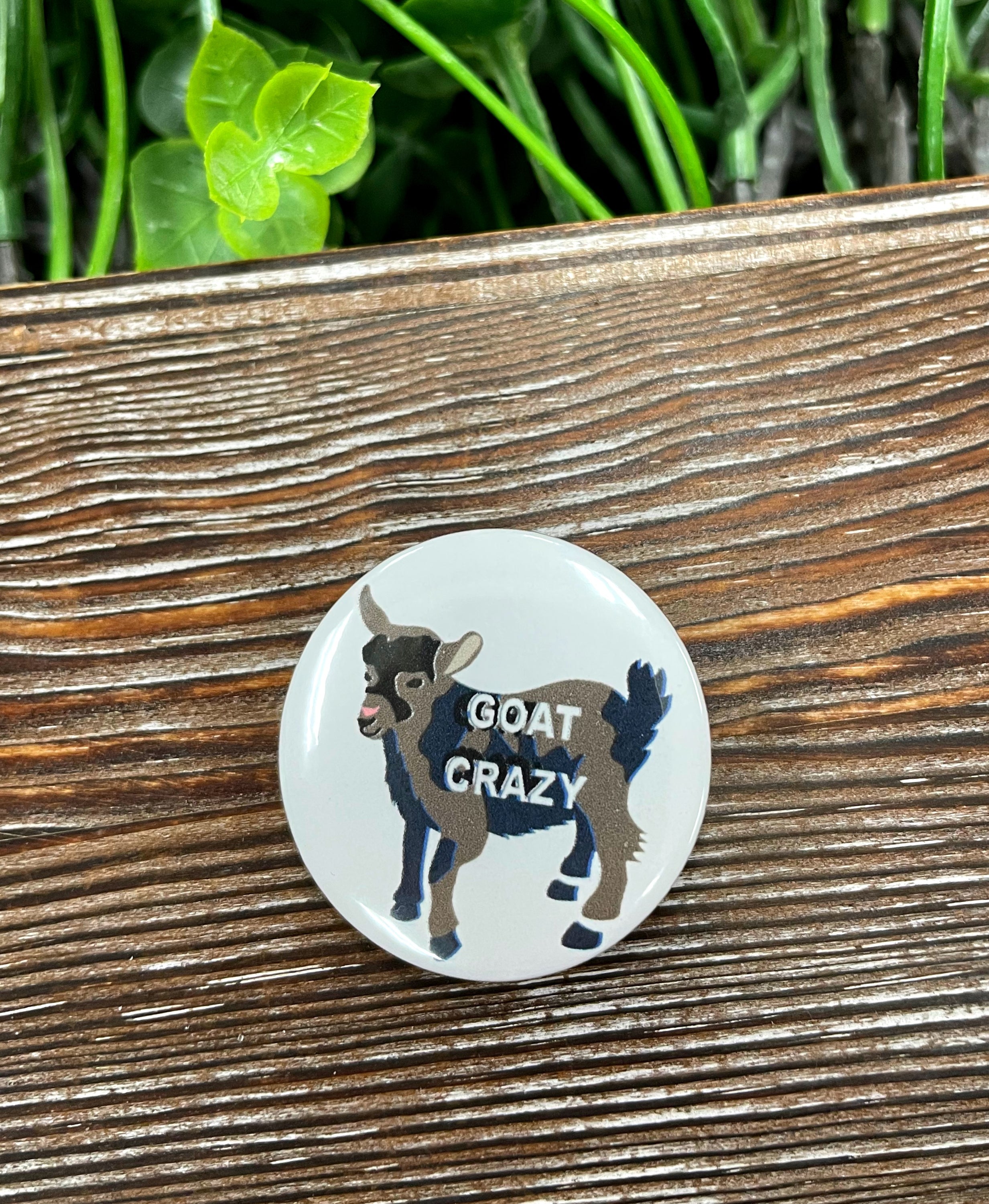 A vibrant 1.25-inch Goat Crazy Graphic Art Button featuring playful goat graphics, perfect for personalizing bags and accessories.