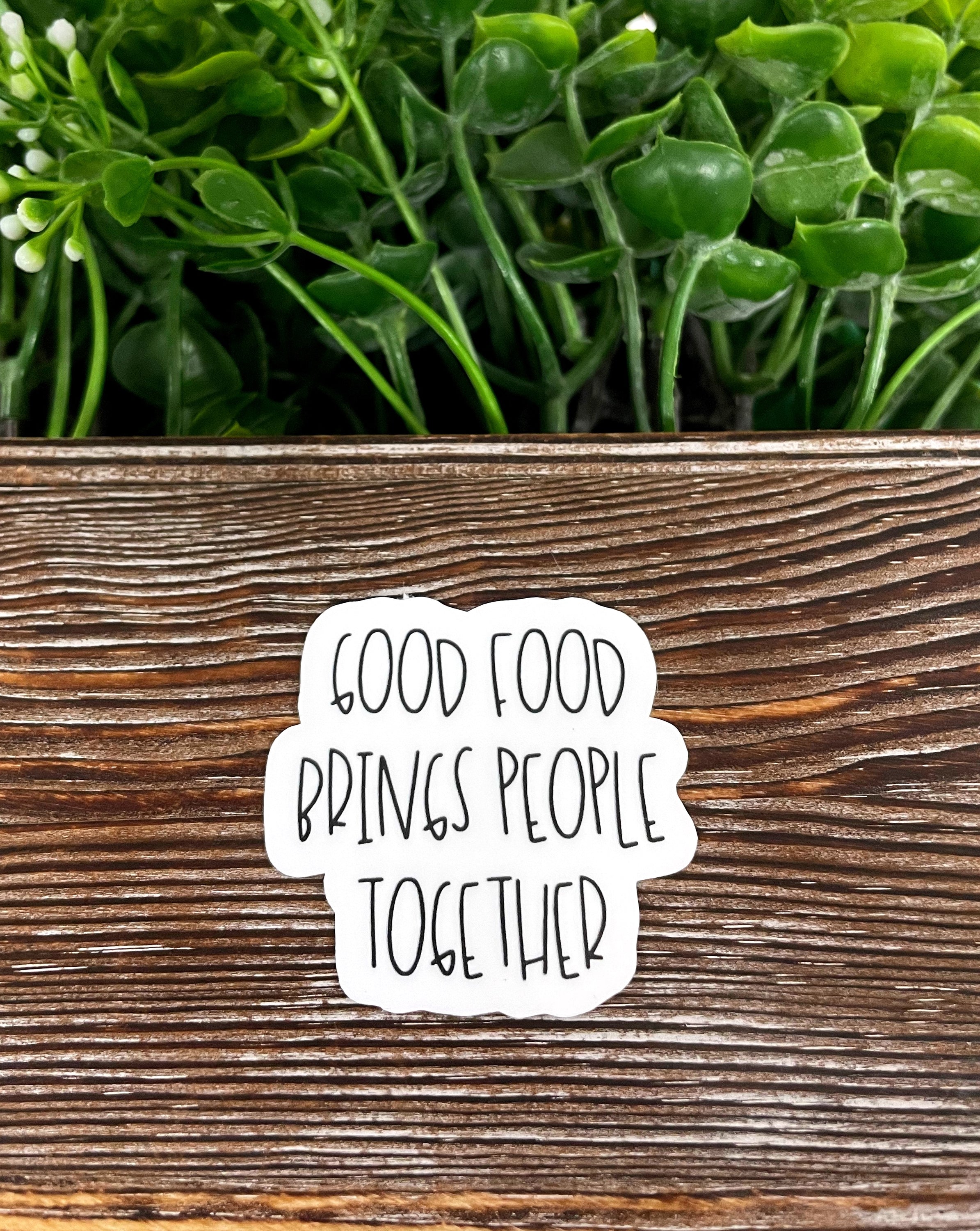 Good Food Brings People Together die cut sticker featuring vibrant graphic art on a smooth surface.