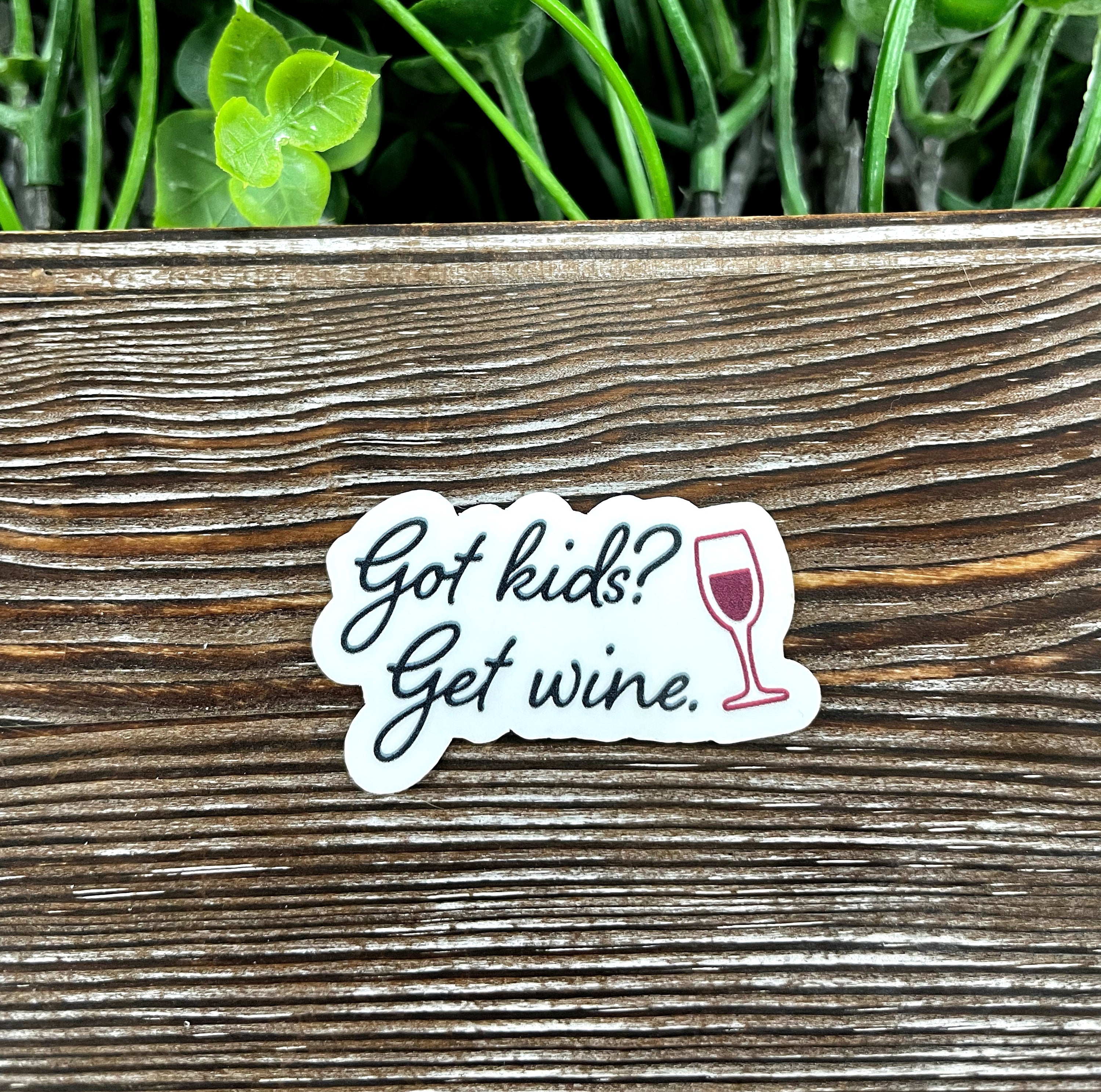 Got Kids, Get Wine die cut sticker on a smooth surface, showcasing vibrant colors and graphic art design.