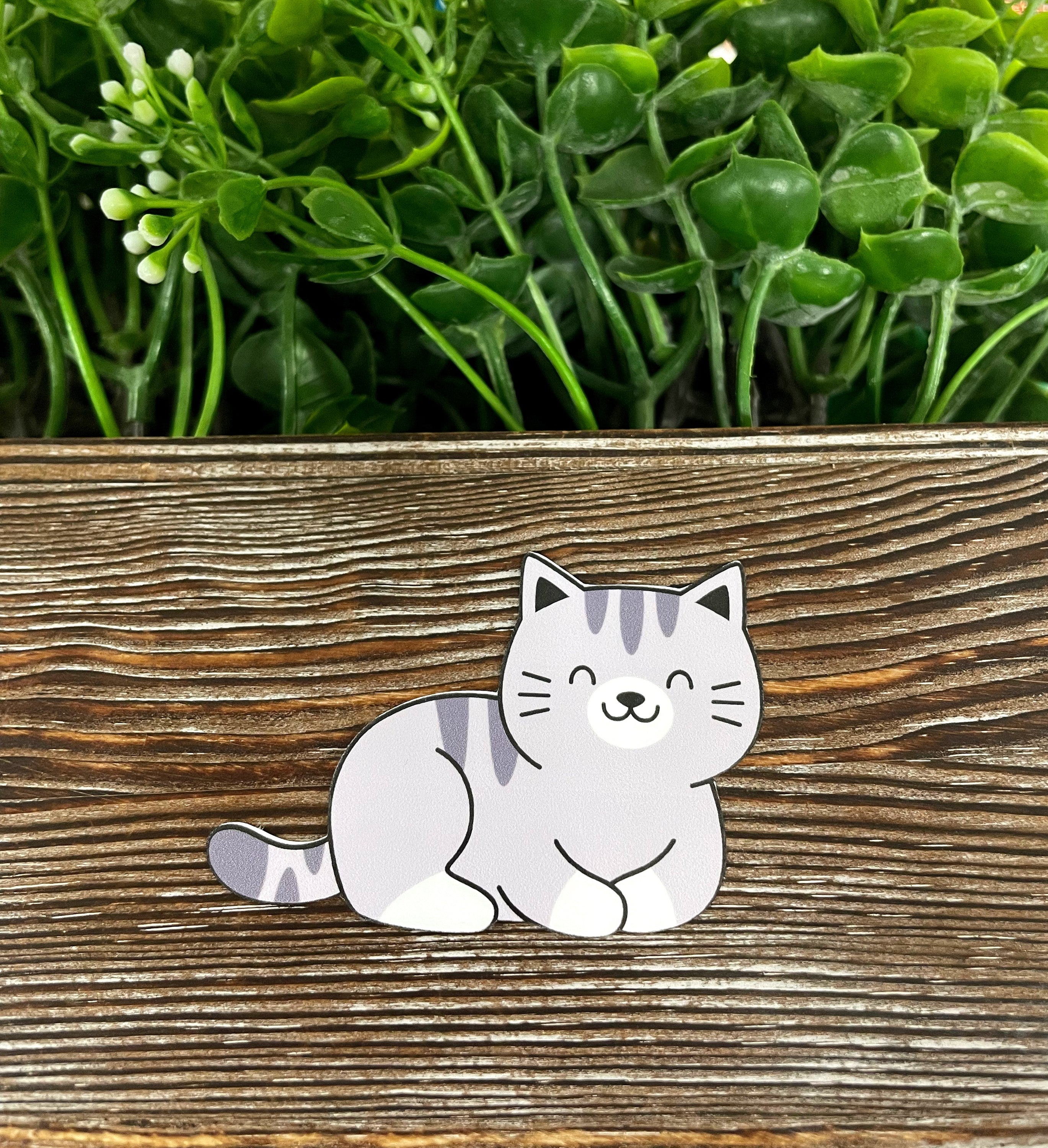 Happy Cute Cat die cut sticker on a smooth surface, showcasing vibrant colors and a charming design.