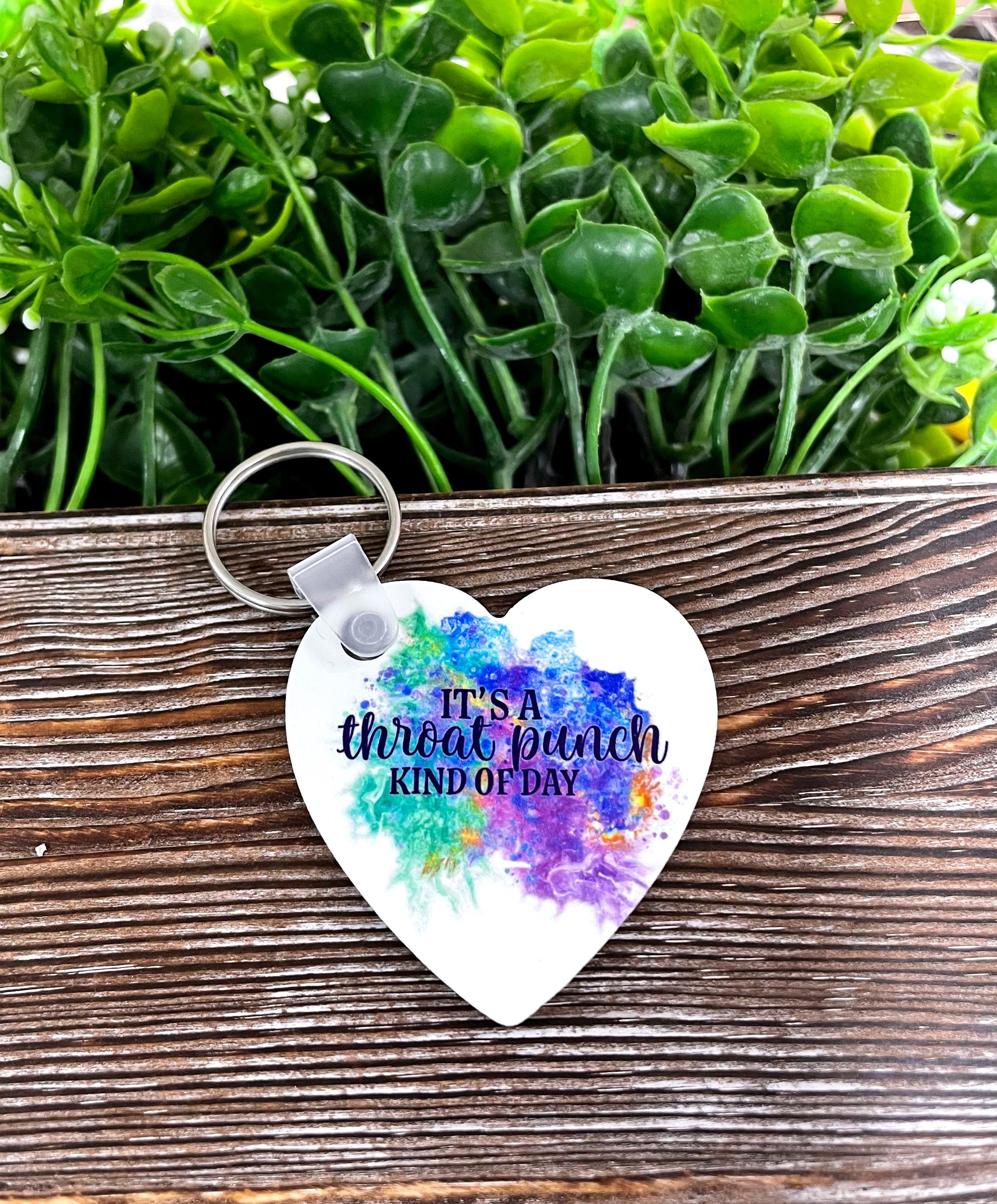 A colorful MDF heart keychain with the phrase 'It's a Throat Punch kind of Day', showcasing a boho style.