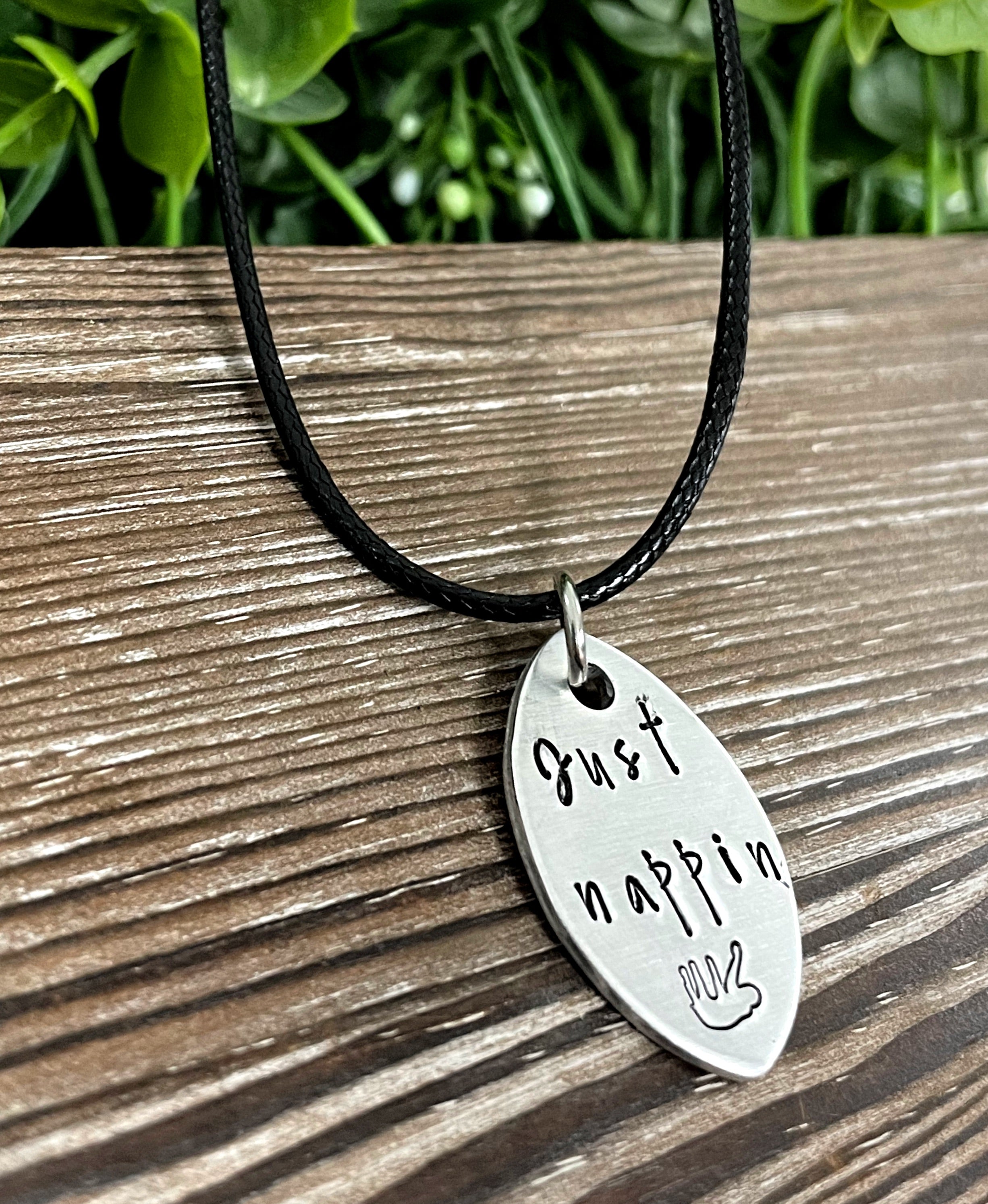 Hand-stamped Just Nappin Sloth necklace featuring unique lettering and design, perfect for animal lovers.