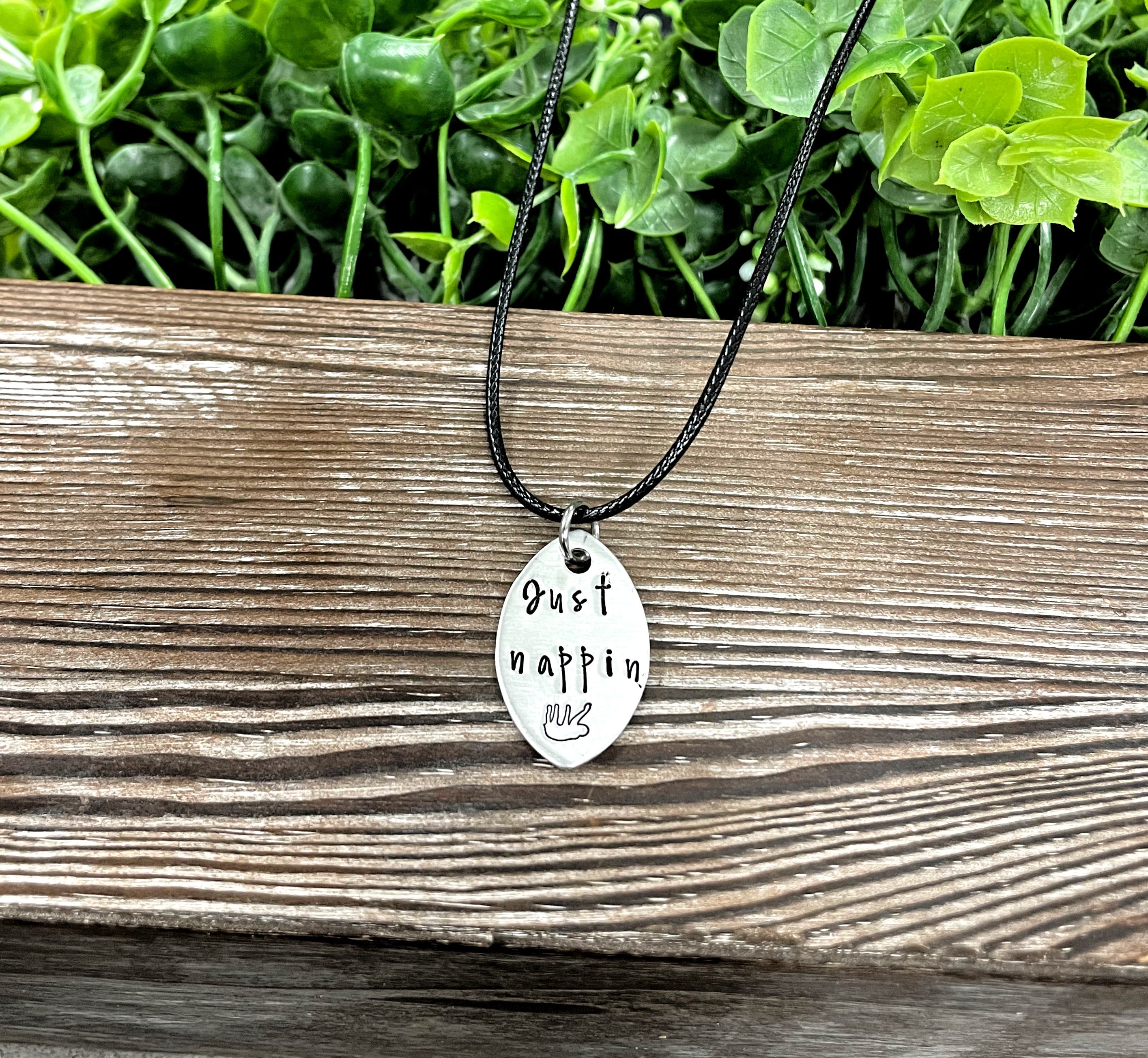 Hand-stamped Just Nappin Sloth necklace featuring unique lettering and design, perfect for animal lovers.