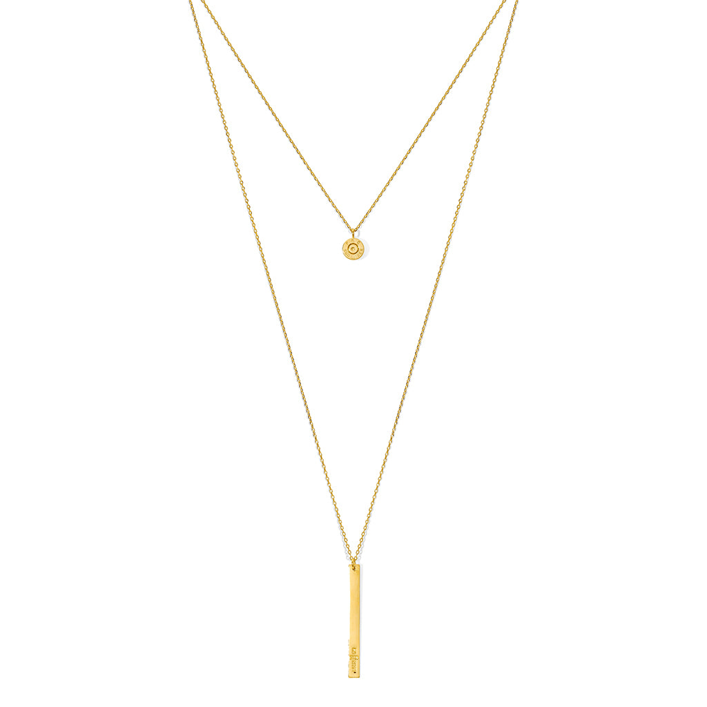 Layered Bar Bullet Necklace featuring recycled brass and bullet fragments, with a bar inscribed with 'peace' in Khmer, showcasing its unique design.