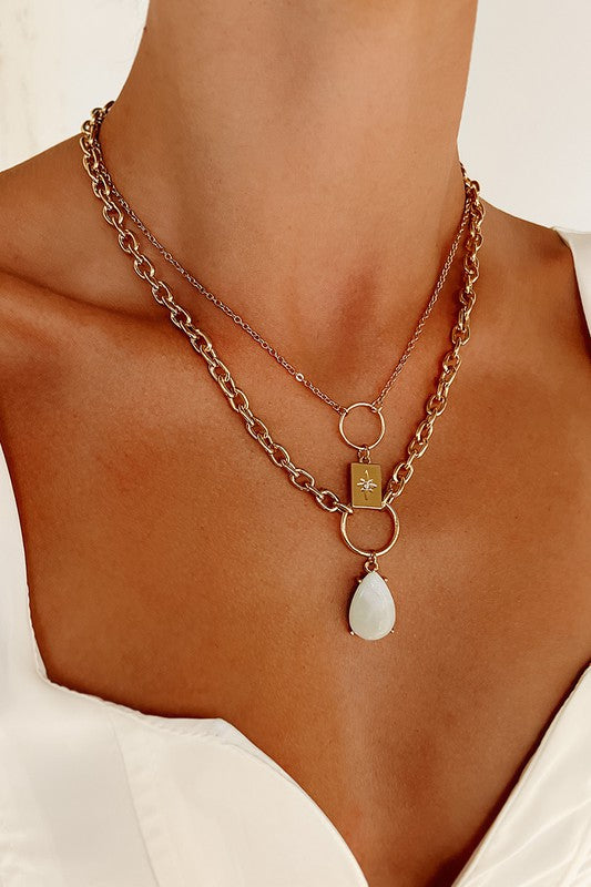 Layered Stone Necklace featuring gold color, teardrop stone, star charm, and rhinestone details on a cable chain.