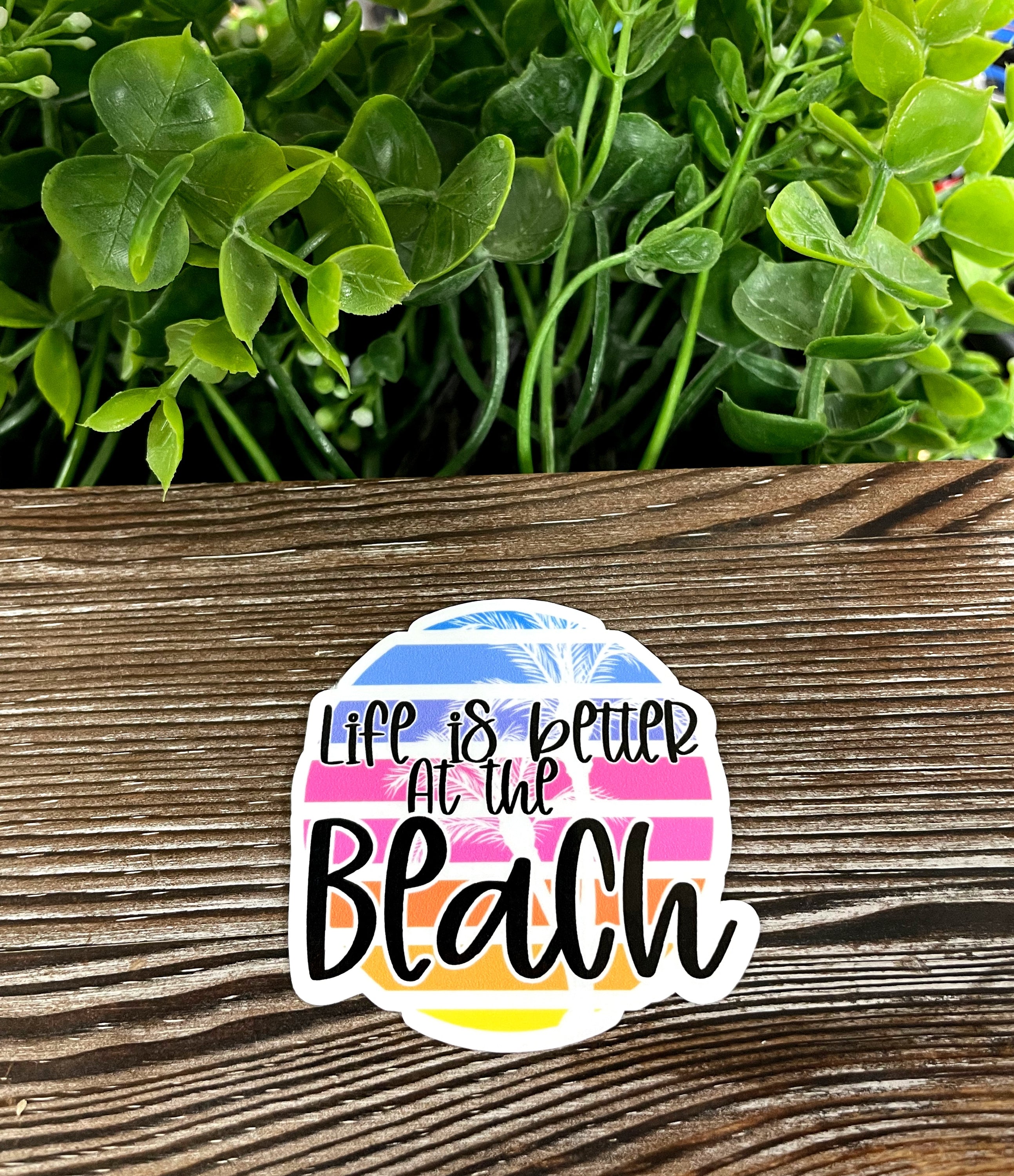 Die cut vinyl sticker featuring the phrase 'Life is Better at the Beach' with a boho design, perfect for personalizing smooth surfaces.