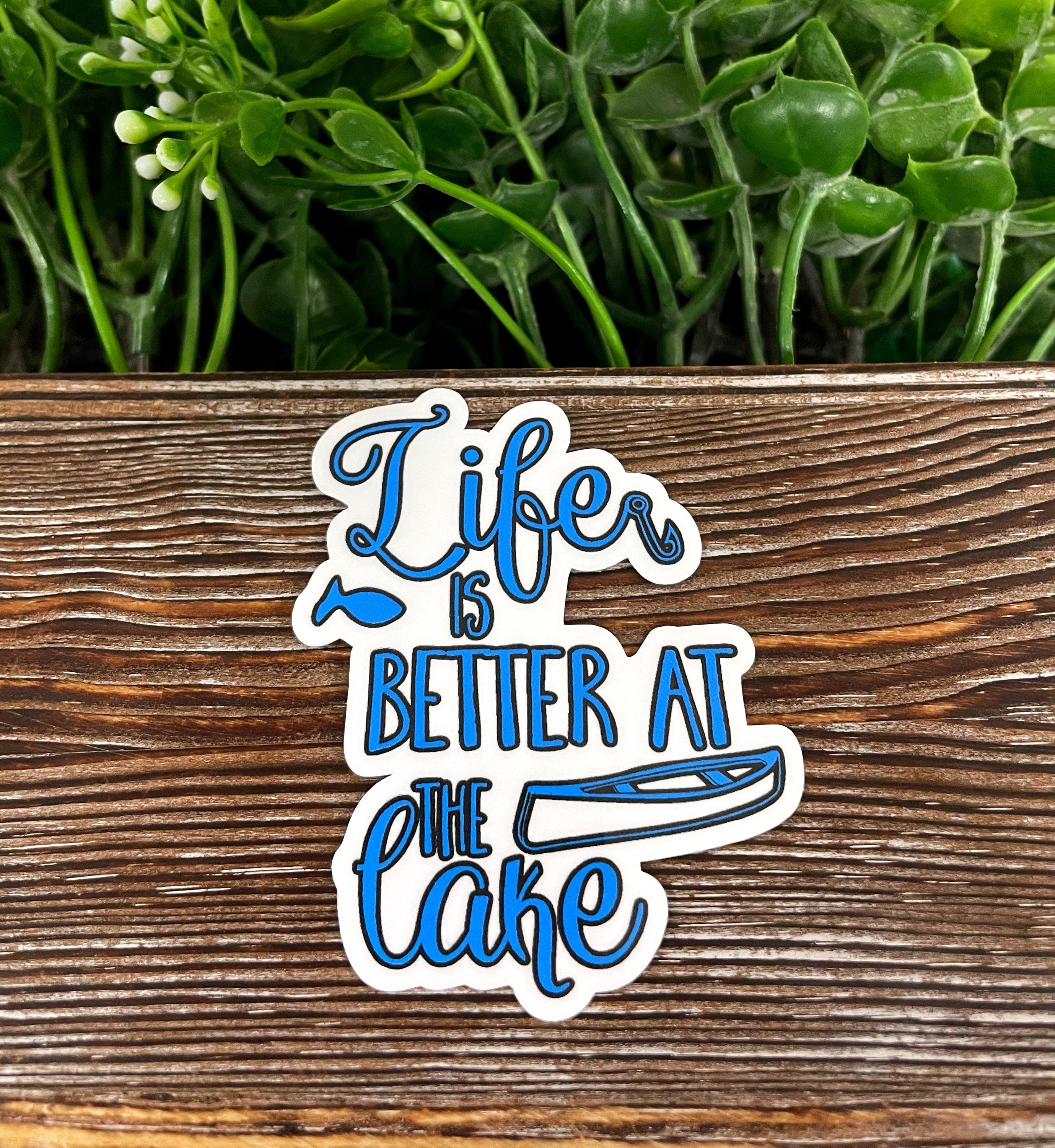 Die cut vinyl sticker featuring the phrase 'Life is Better at the Lake' with a boho design, perfect for personalizing smooth surfaces.