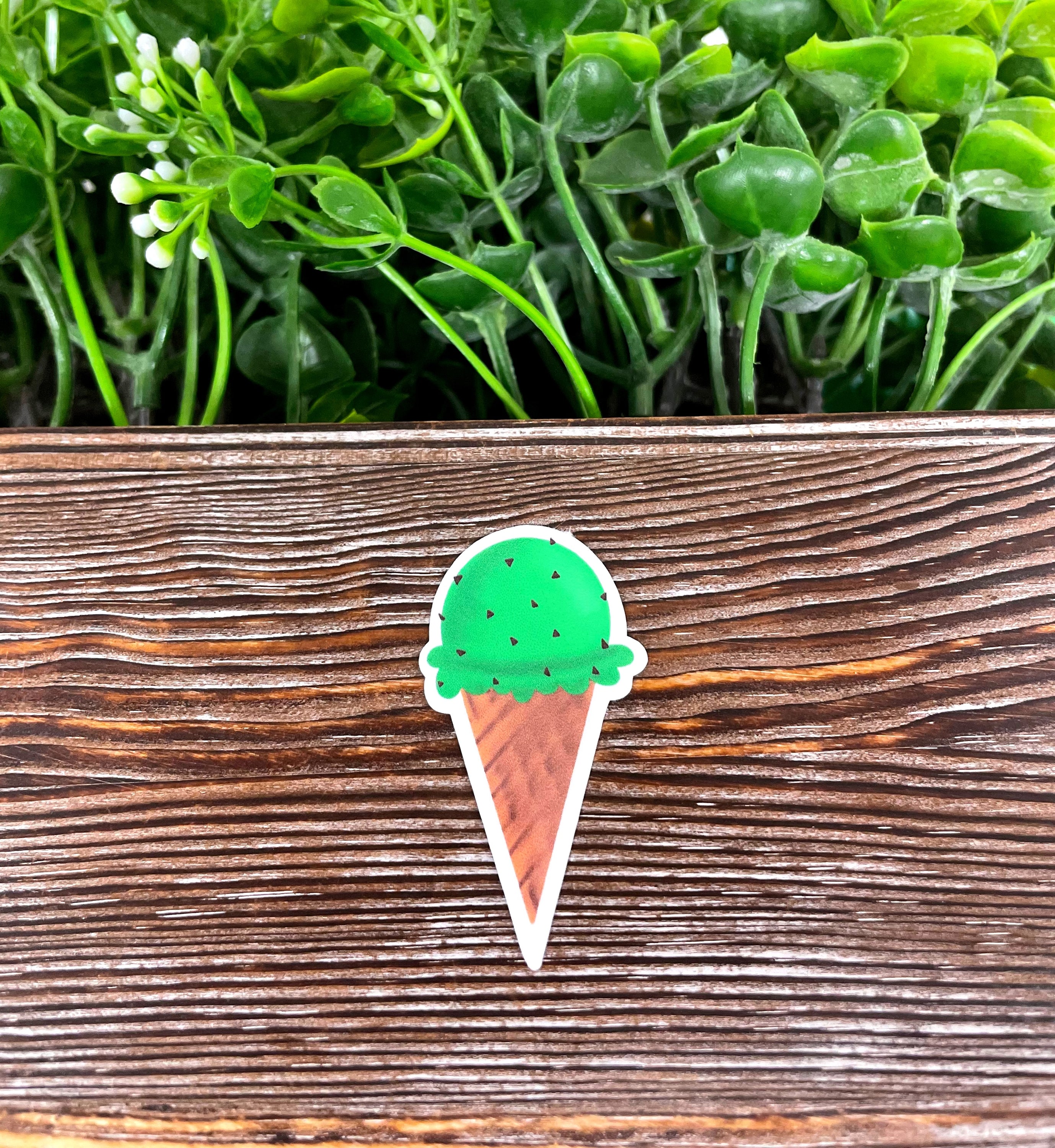 Mint Chocolate Chip Ice Cream Cone Sticker on a smooth surface, showcasing vibrant colors and die cut design.