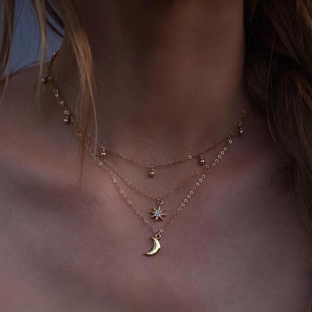 A beautiful three-layer necklace featuring a crescent moon, a star, and round beads, crafted from high-quality zinc alloy.