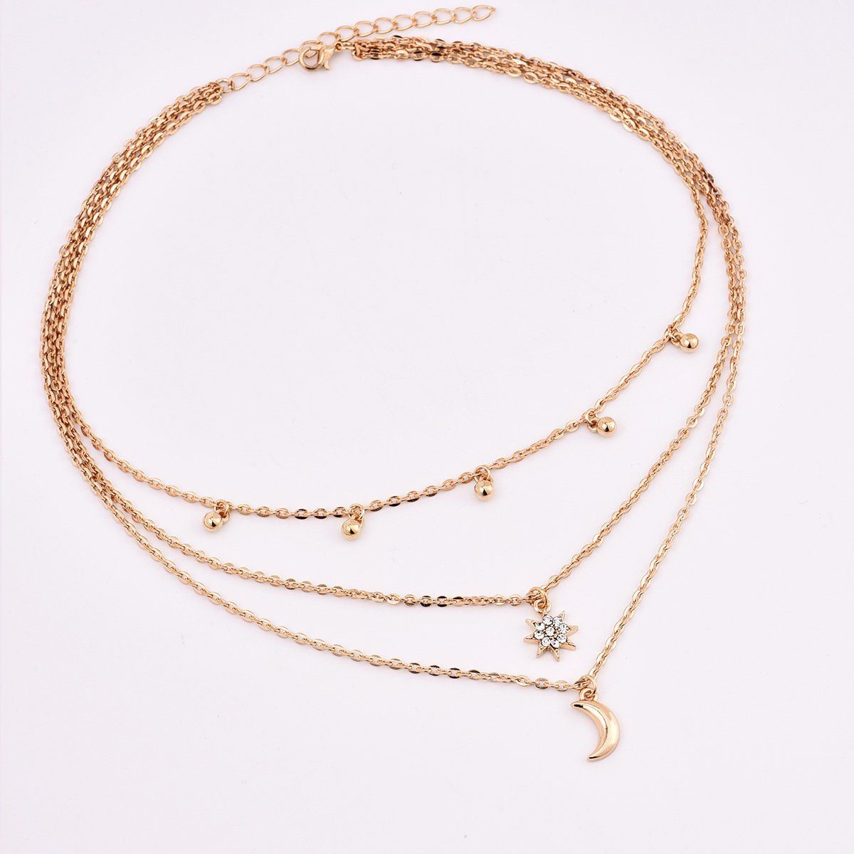 A beautiful three-layer necklace featuring a crescent moon, a star, and round beads, crafted from high-quality zinc alloy.