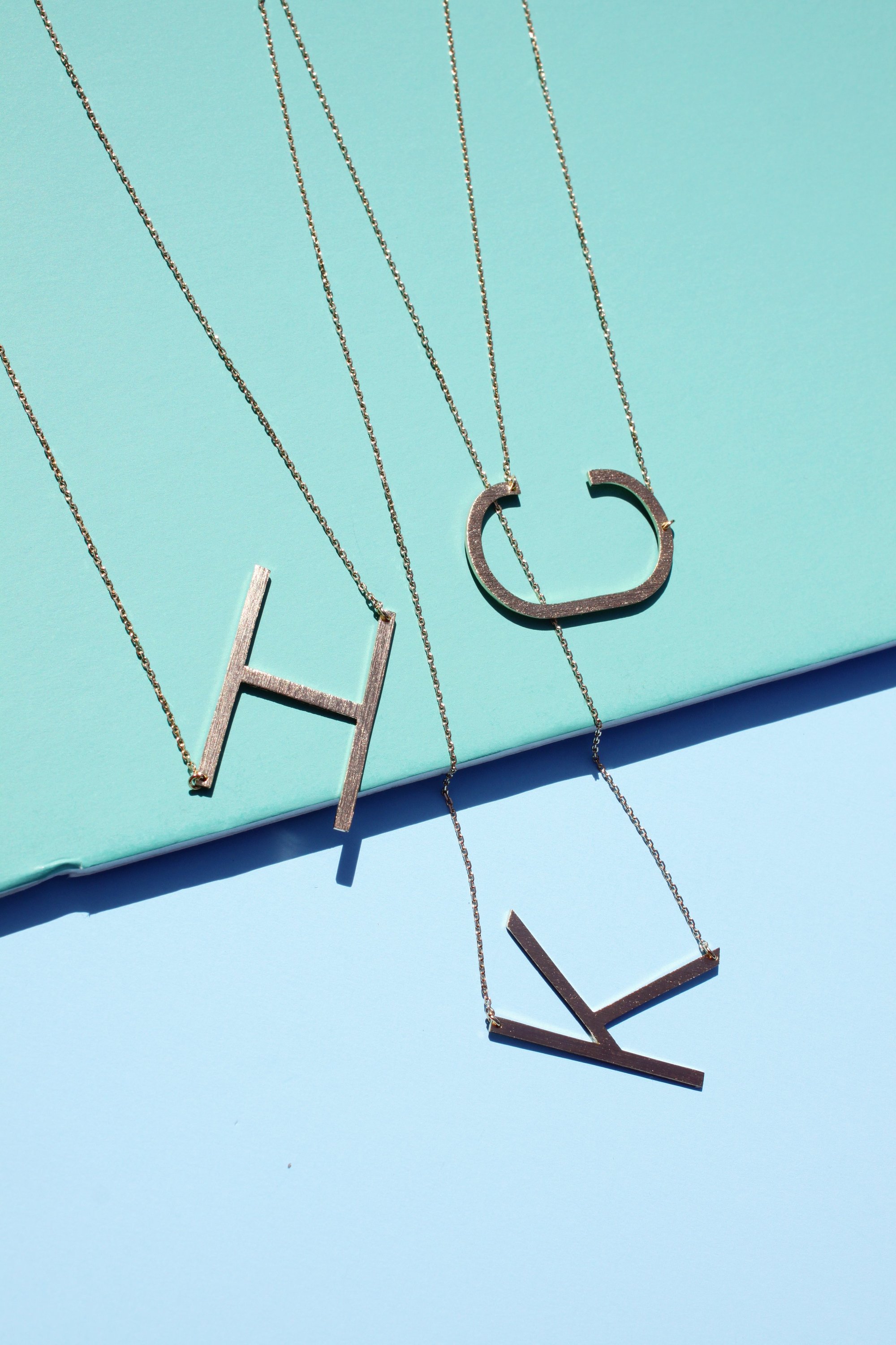 Gold-dipped brass Monogram Collection Initial Necklace with adjustable chain and elegant design.