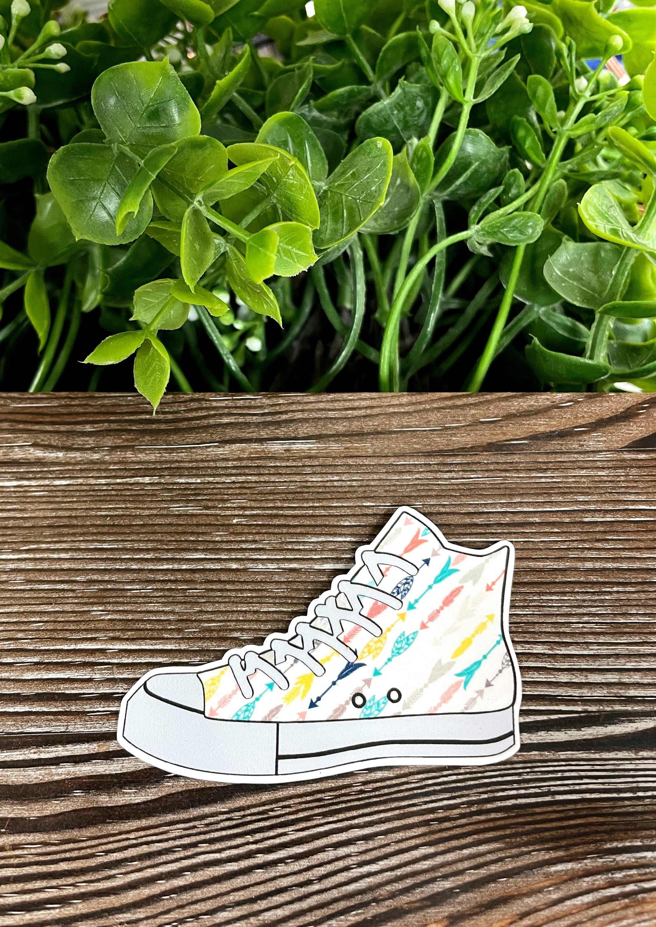 Multicolored Arrows High Top Shoes Sticker on a smooth surface, showcasing vibrant colors and unique design.