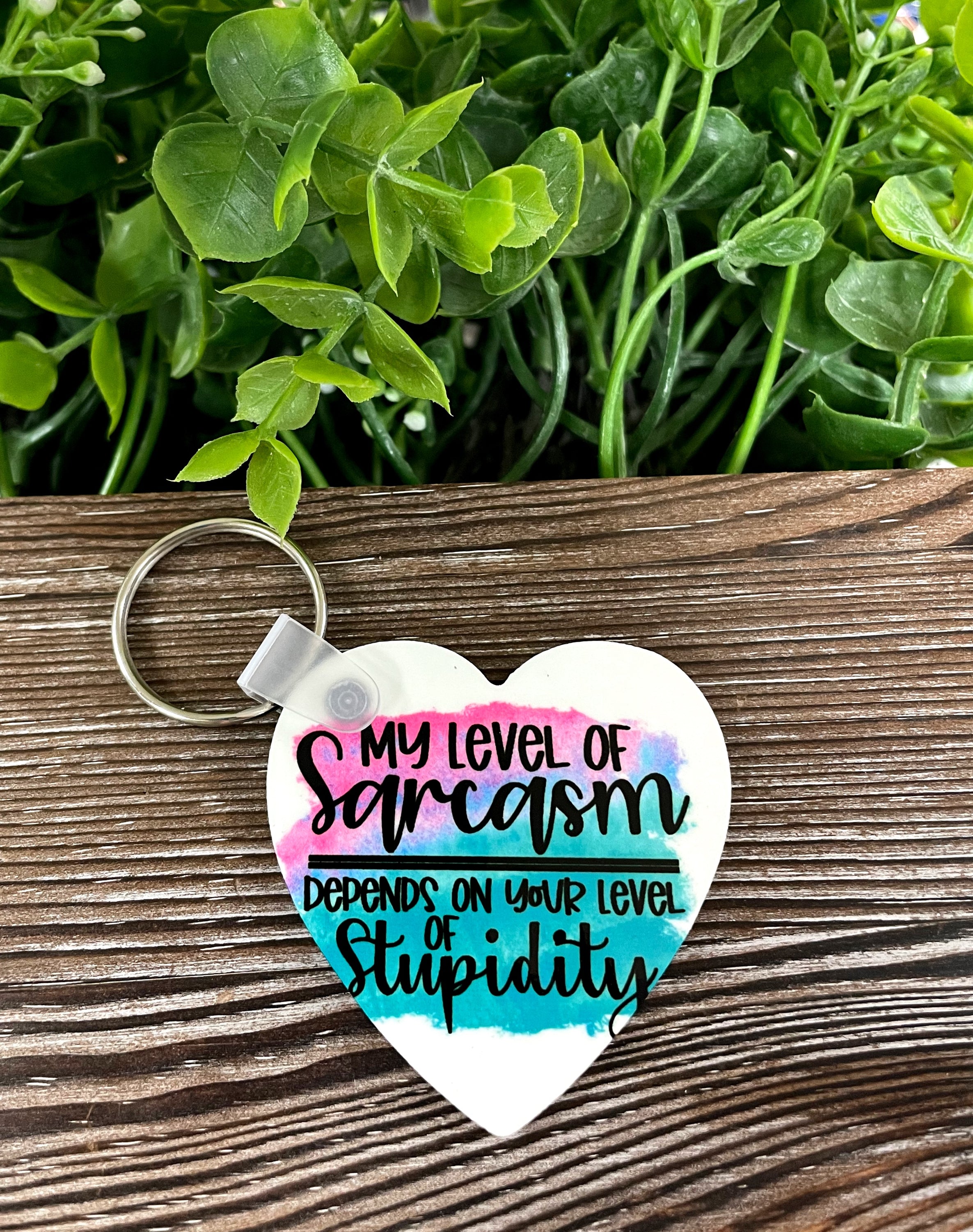 A lightweight MDF heart keychain with a sarcastic quote printed on it, showcasing a humorous design.