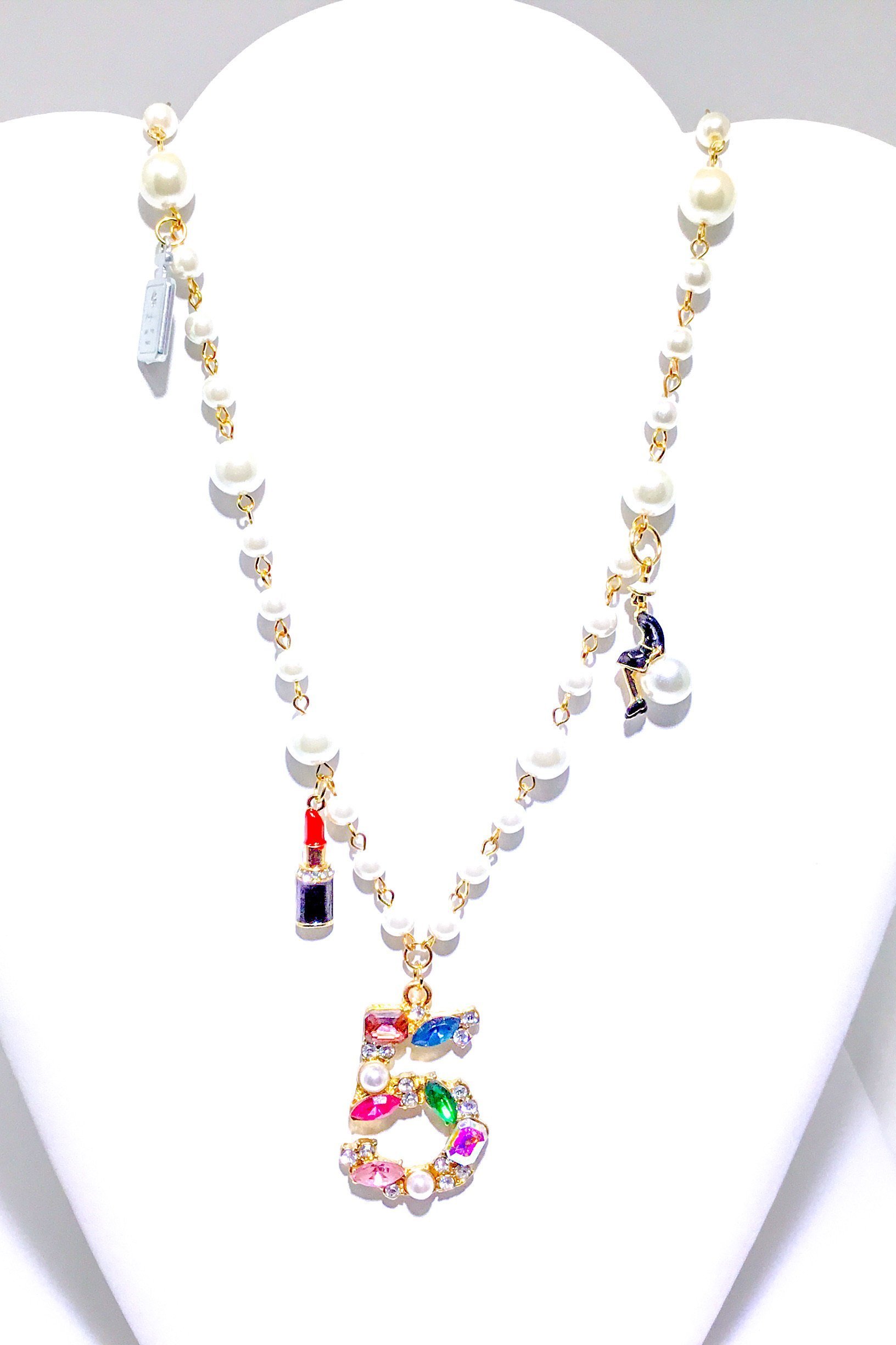 Kensington Necklace featuring embellished pearl strands in gold and multi colors, showcasing elegance and style.