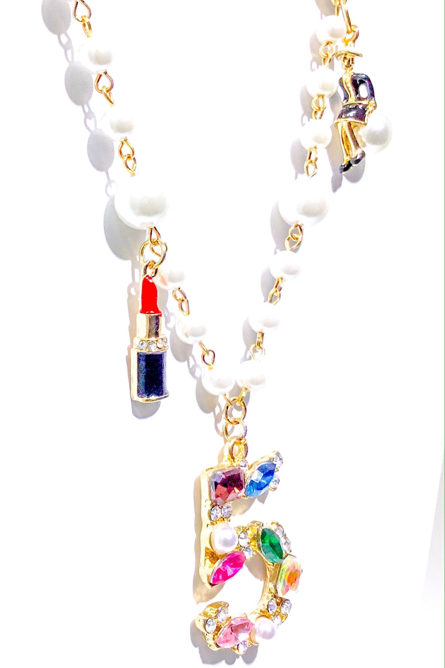 Kensington Necklace featuring embellished pearl strands in gold and multi colors, showcasing elegance and style.