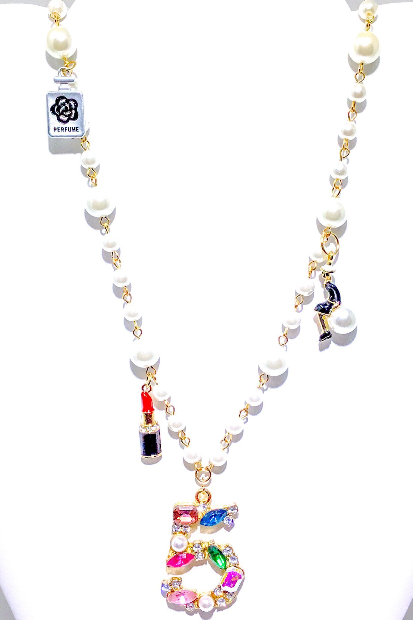 Kensington Necklace featuring embellished pearl strands in gold and multi colors, showcasing elegance and style.