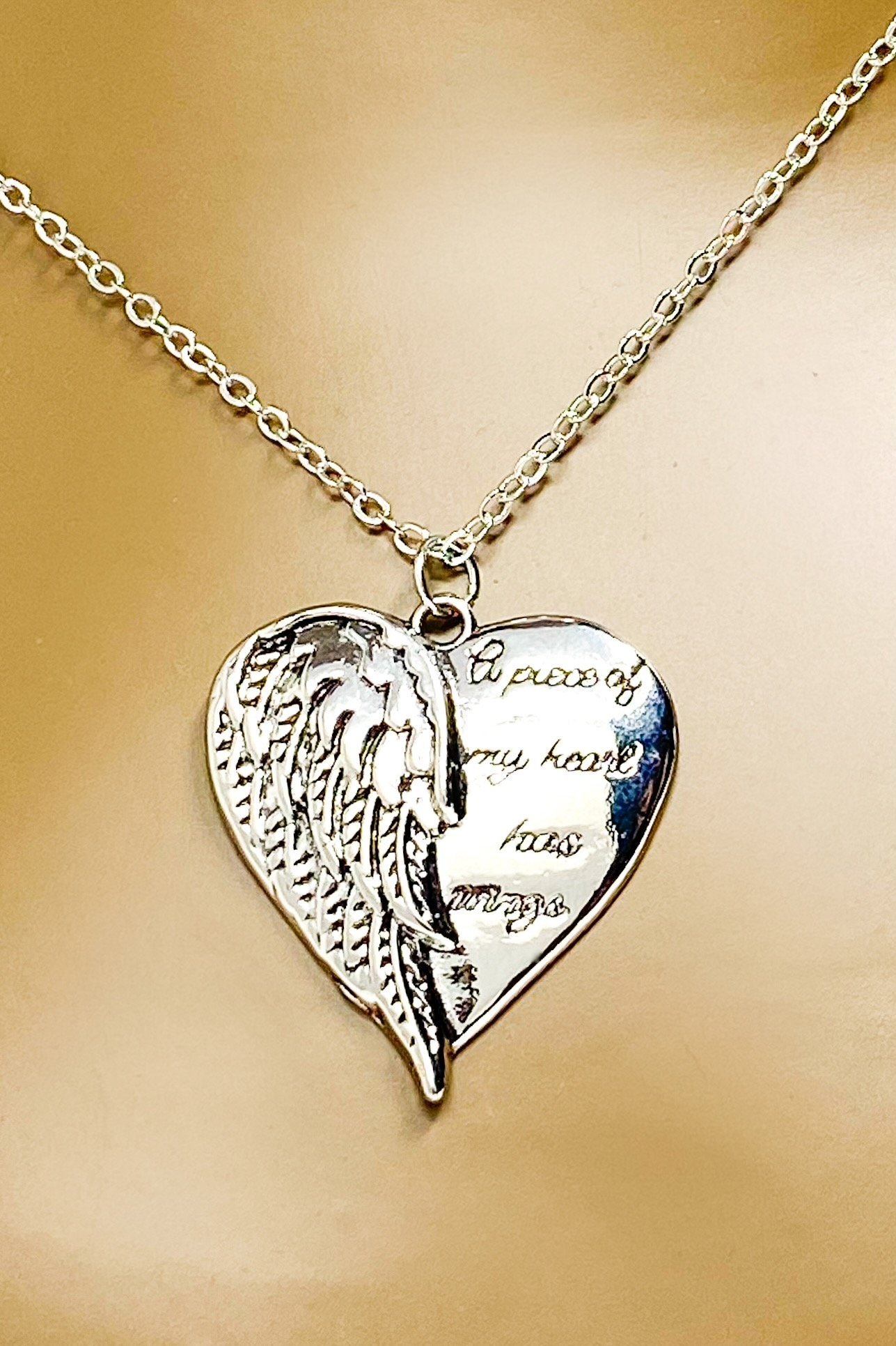 A silver remembrance necklace featuring wings, symbolizing love and memory, crafted from high-quality zinc alloy.