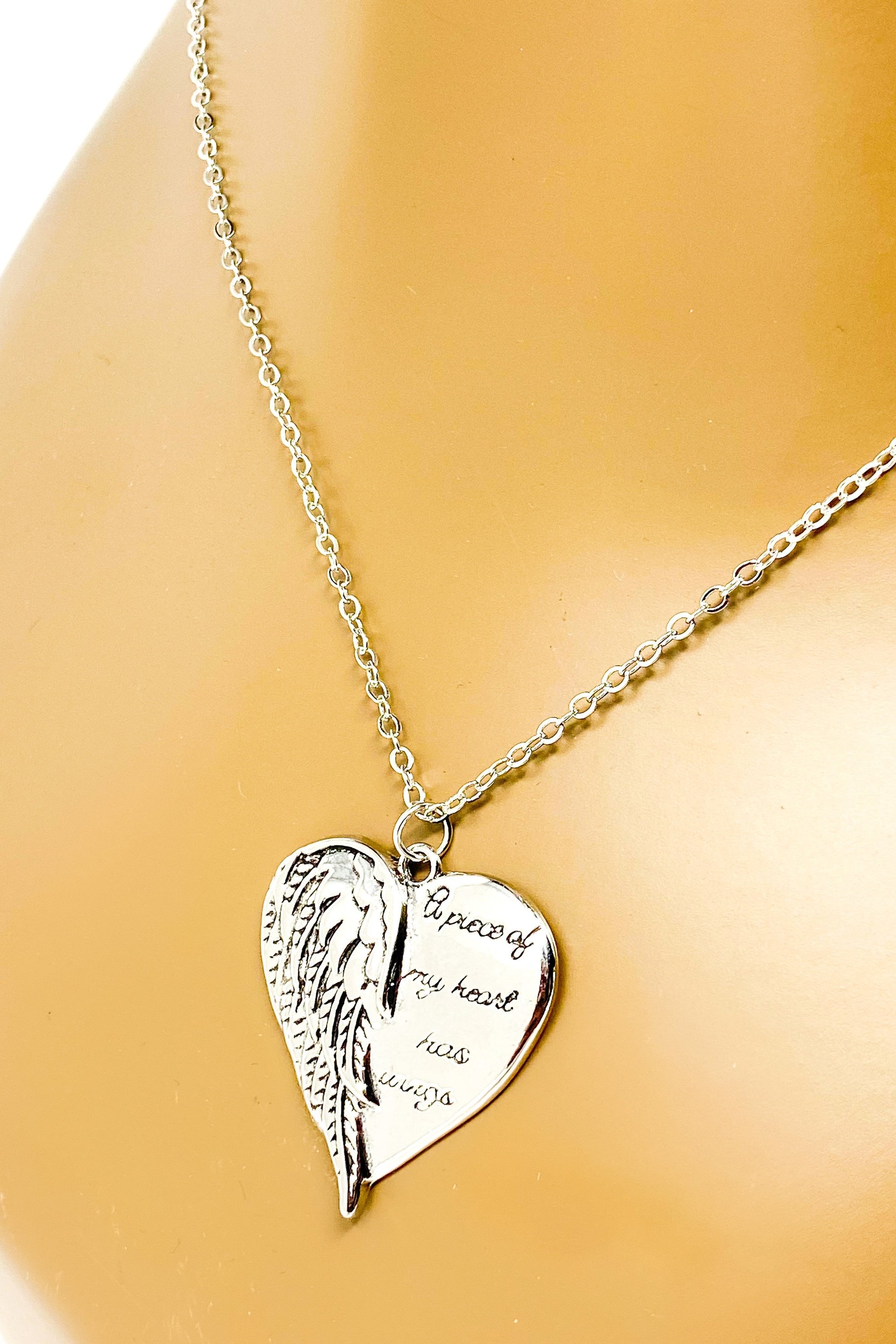 A silver remembrance necklace featuring wings, symbolizing love and memory, crafted from high-quality zinc alloy.