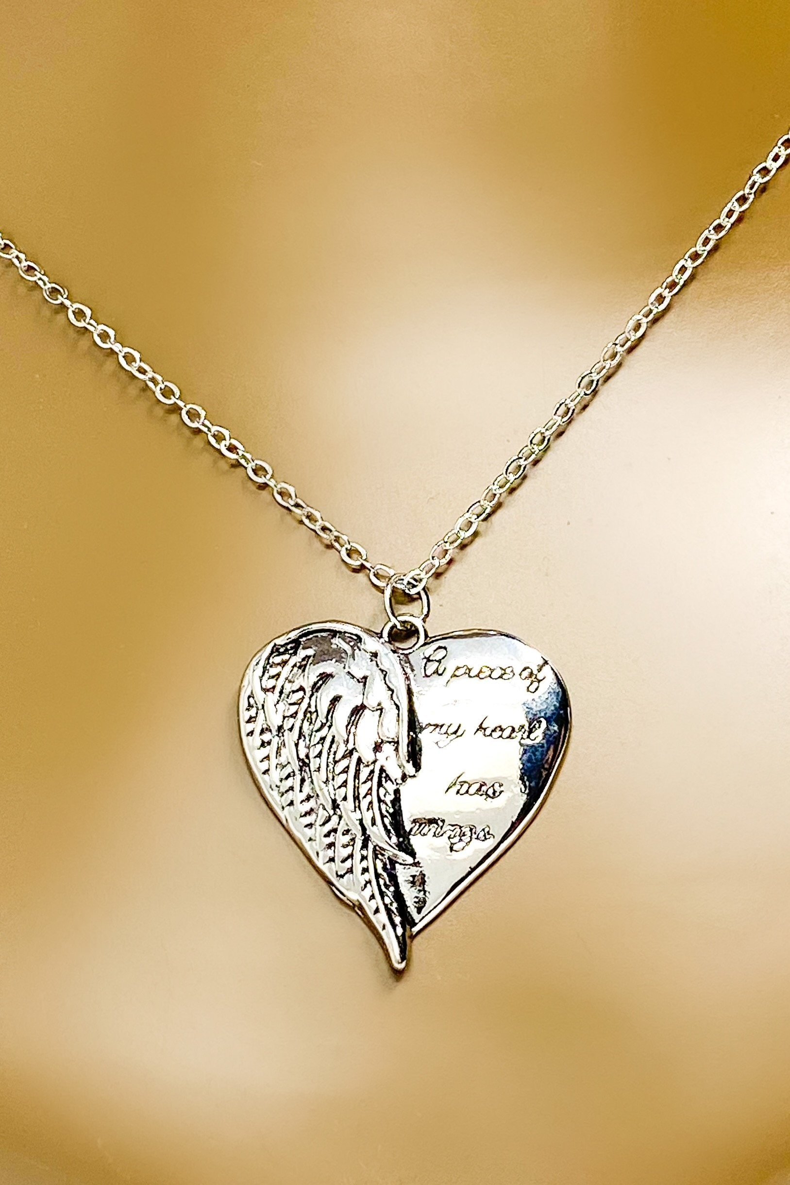 A silver remembrance necklace featuring wings, symbolizing love and memory, crafted from high-quality zinc alloy.