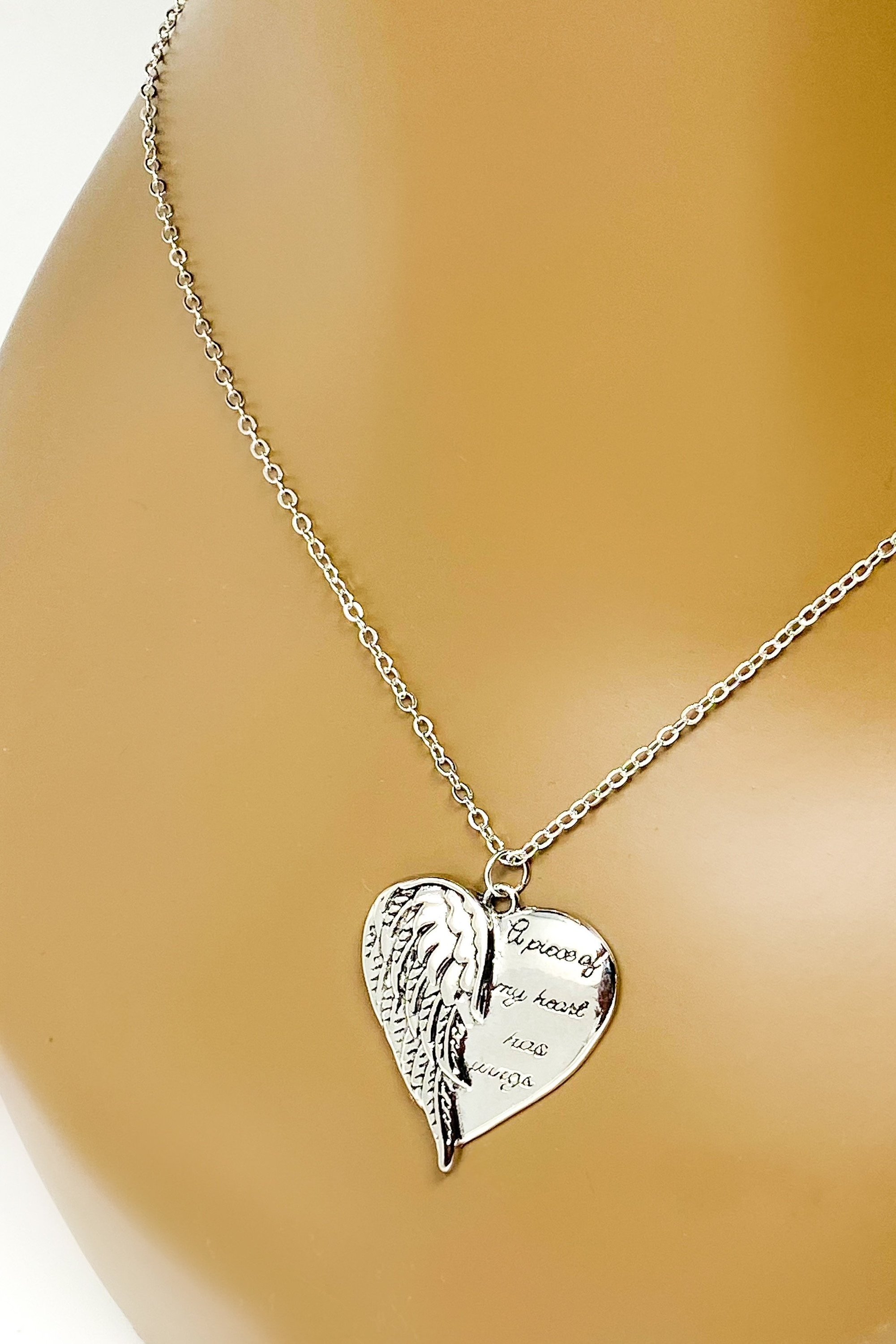 A silver remembrance necklace featuring wings, symbolizing love and memory, crafted from high-quality zinc alloy.