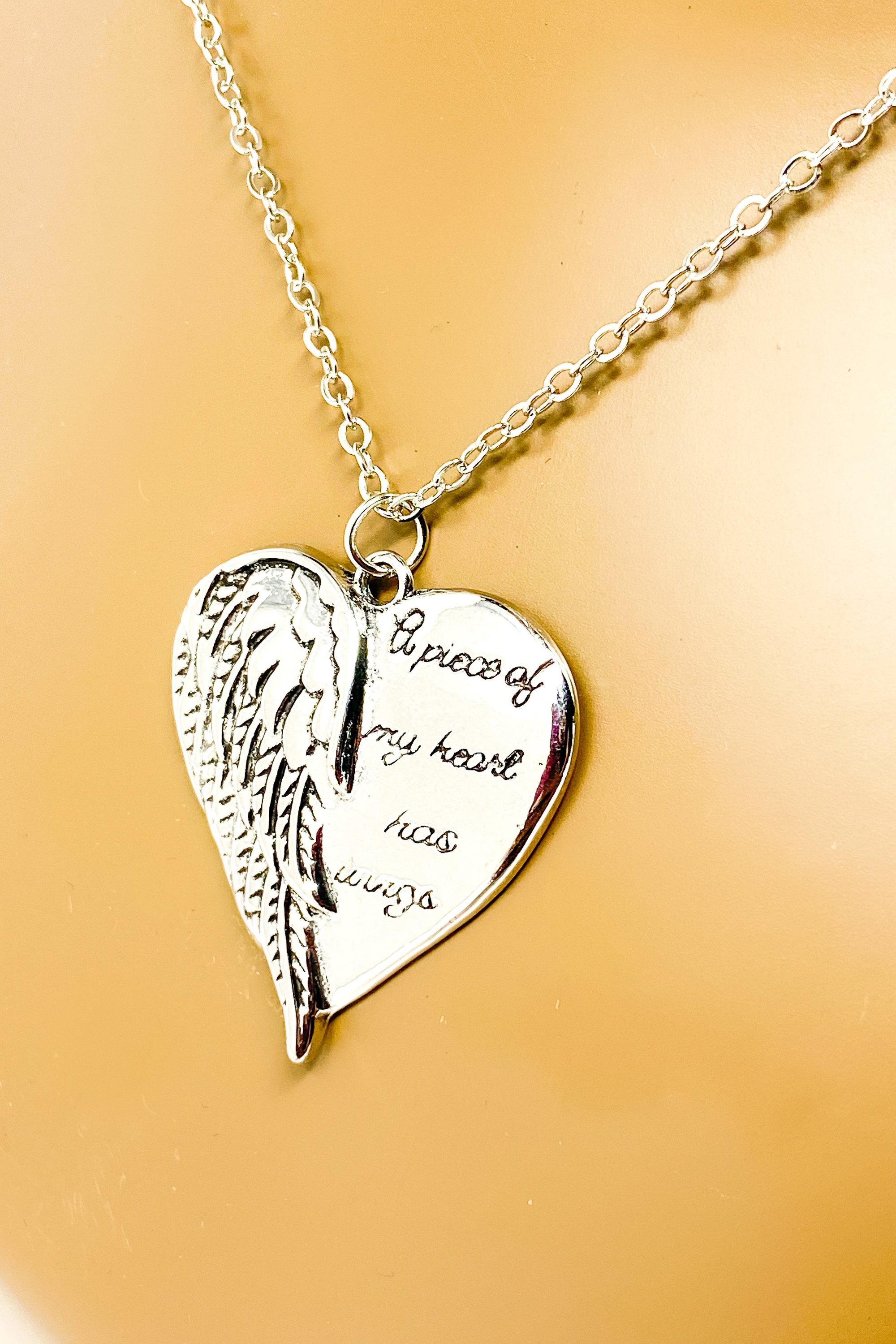 A silver remembrance necklace featuring wings, symbolizing love and memory, crafted from high-quality zinc alloy.