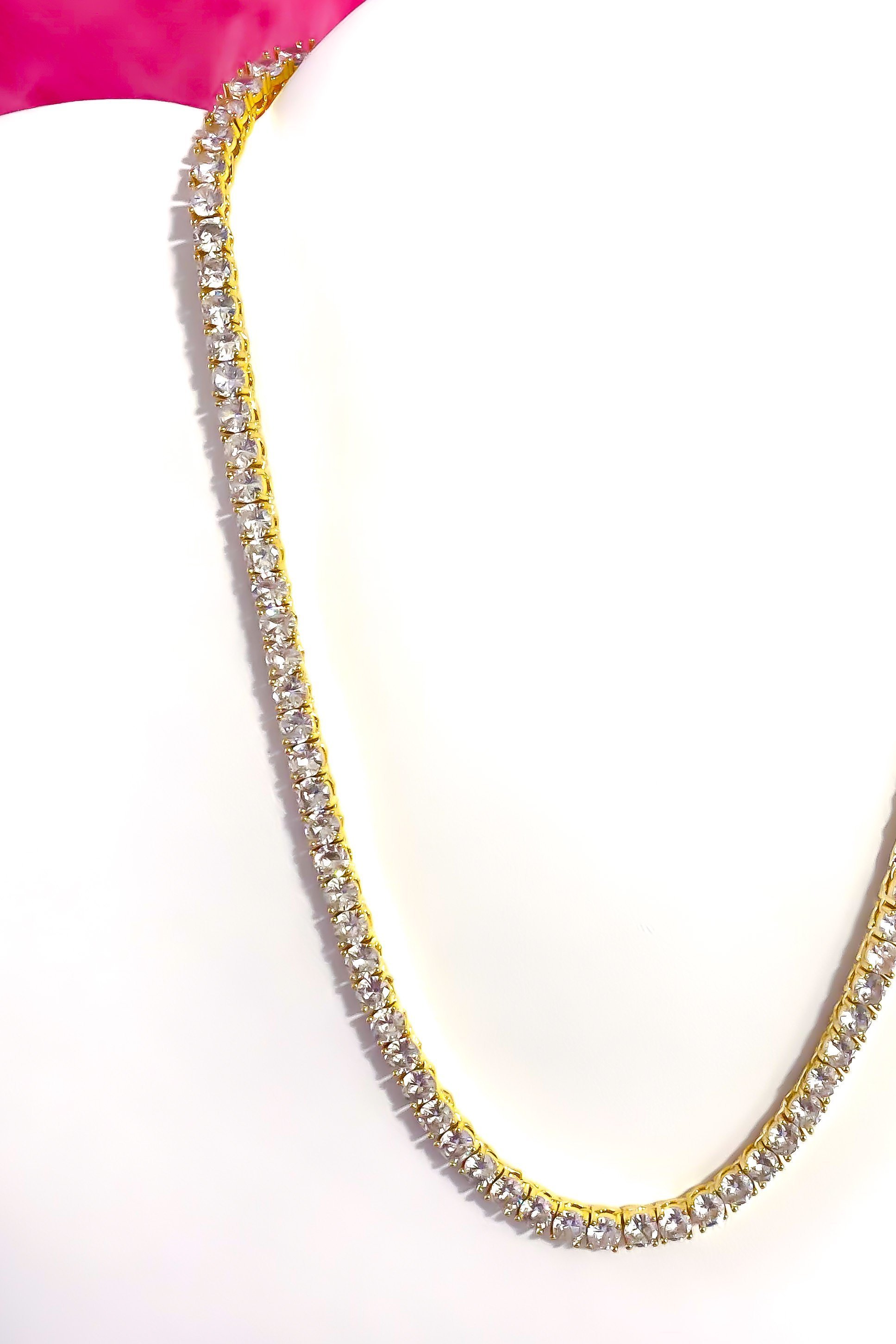 So Icy Tennis Necklace featuring a 4mm row design in high polished 14K white gold with flawless VVS simulants, available in silver and gold.