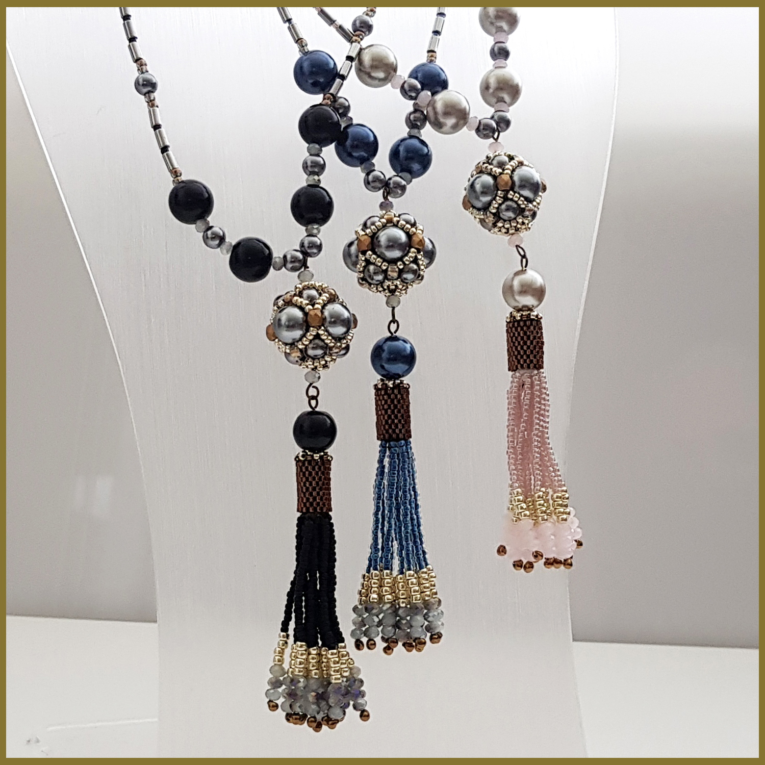 A stunning black beaded tassel necklace featuring silver hematite tubes, handmade with Toho and Delica seed beads, showcasing a boho chic design.