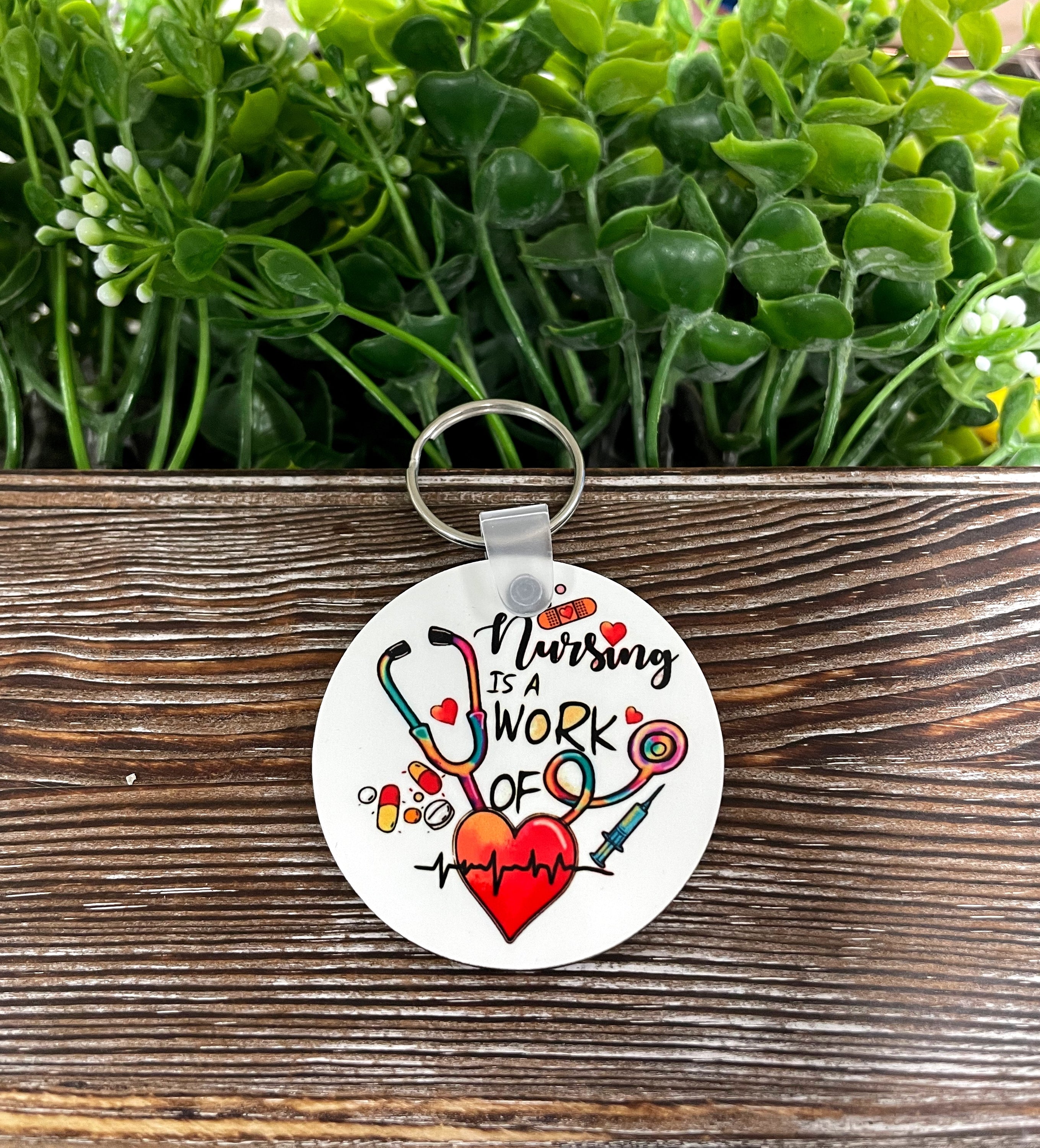 Lightweight MDF round keychain with 'Nursing is a Work of Heart' design, showcasing a boho style, perfect for nurses.