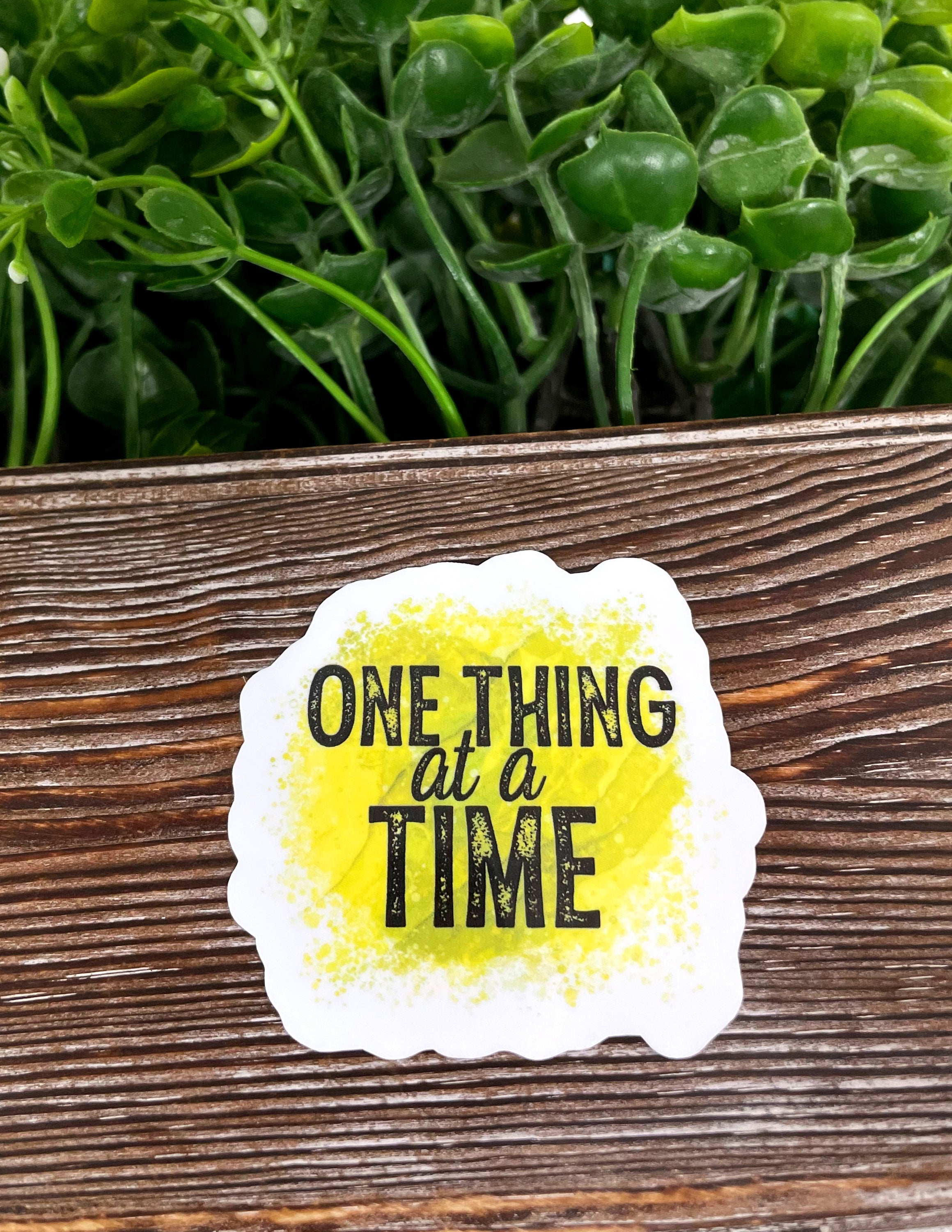 One Thing at a Time Sticker featuring vibrant colors and a die cut design, perfect for personalizing various surfaces.