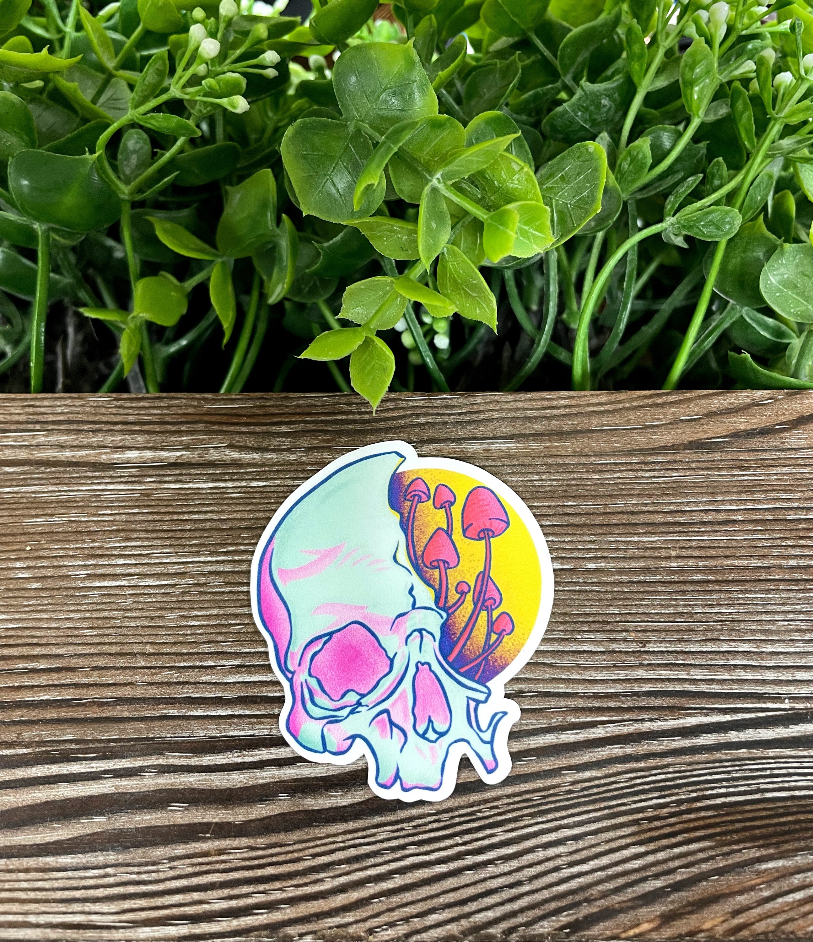 A vibrant die cut vinyl sticker featuring a partial skull adorned with colorful mushrooms, perfect for personalizing items.