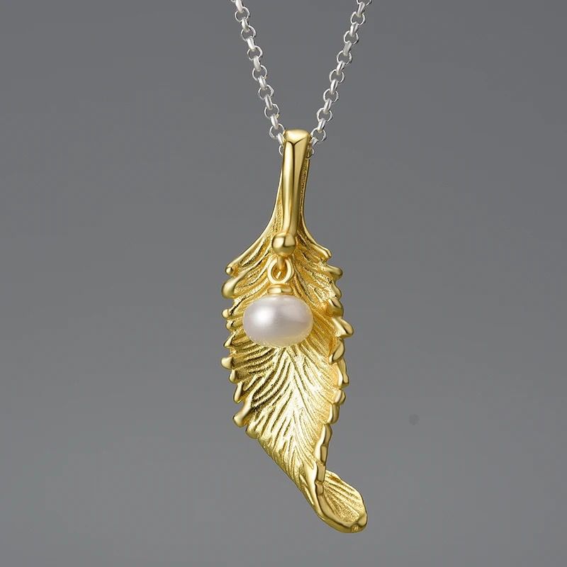 A beautiful Pearl Leaf Necklace featuring a delicate tulip flower pendant in gleaming silver with 18K gold plating.