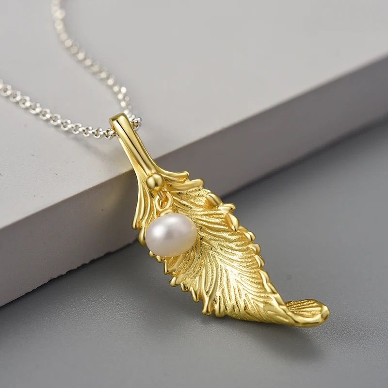 A beautiful Pearl Leaf Necklace featuring a delicate tulip flower pendant in gleaming silver with 18K gold plating.