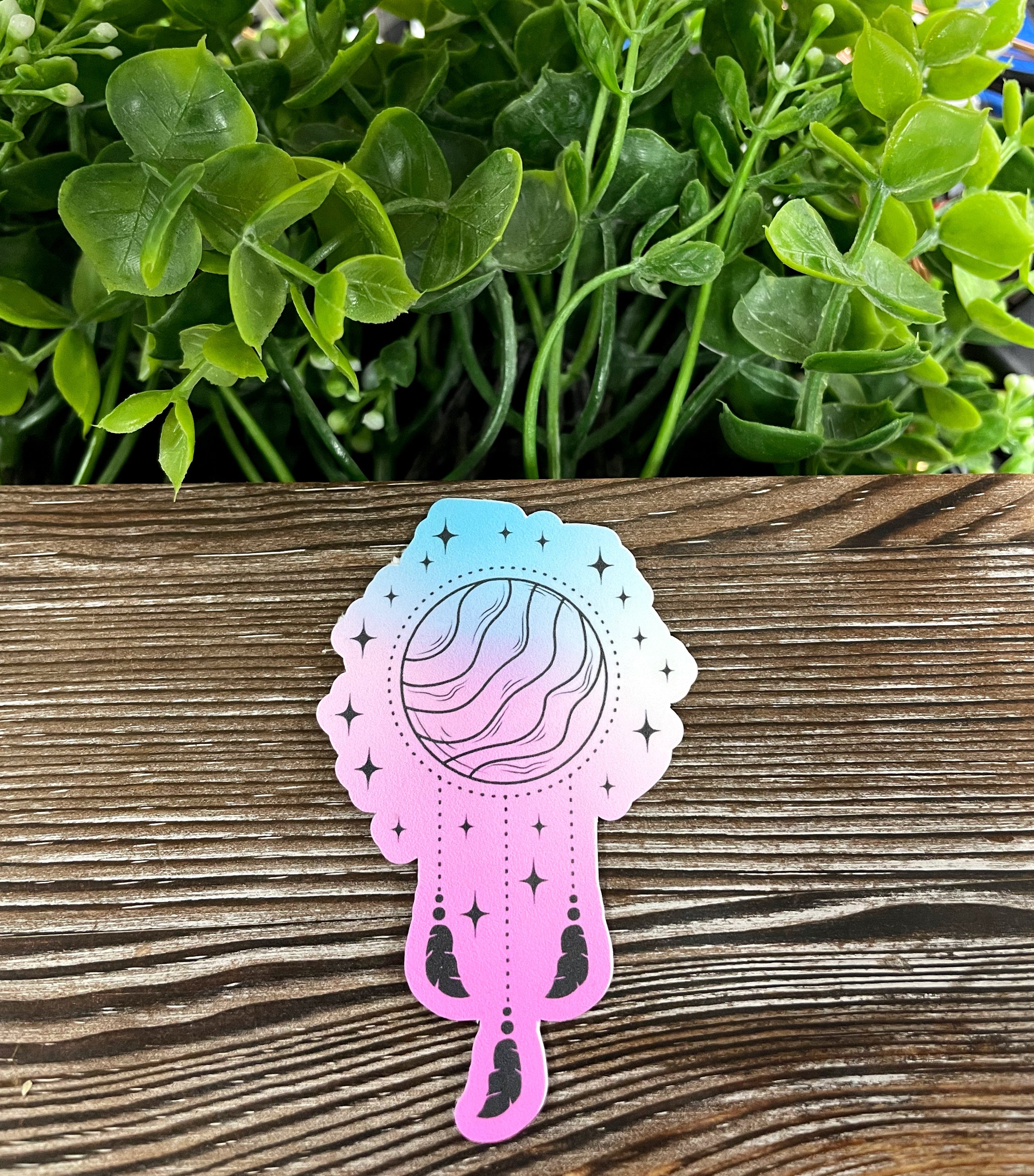 Planet Dreamcatcher die cut vinyl sticker with colorful feathers, perfect for personalizing items.