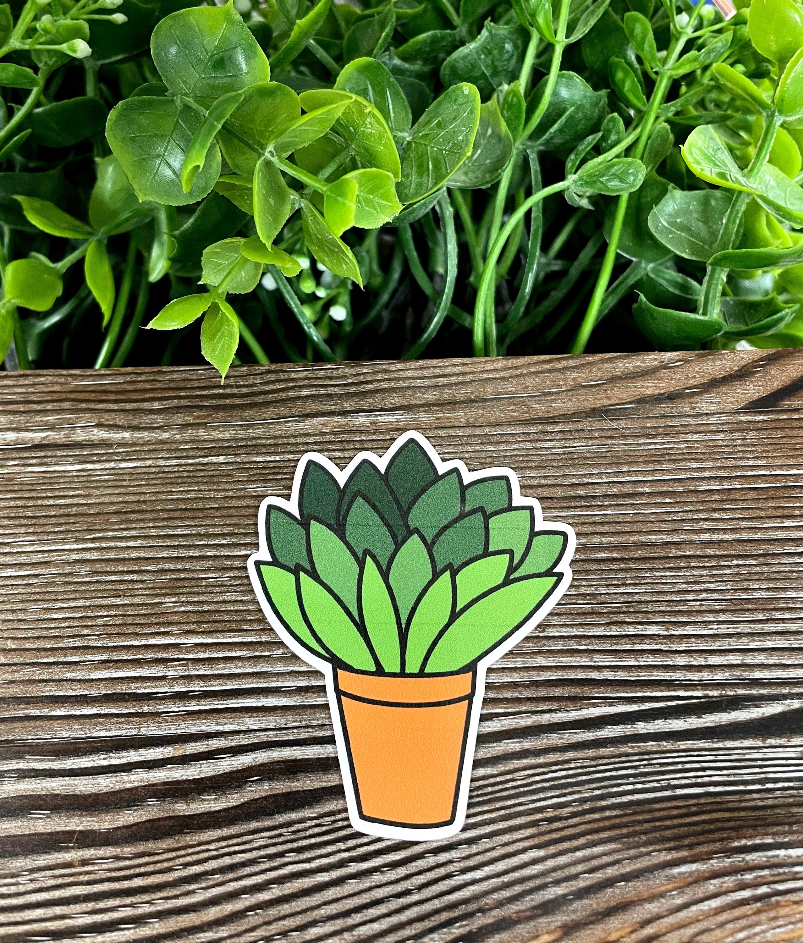 Colorful die cut vinyl sticker featuring plants in a pot, showcasing a boho design, ideal for personalizing various smooth surfaces.