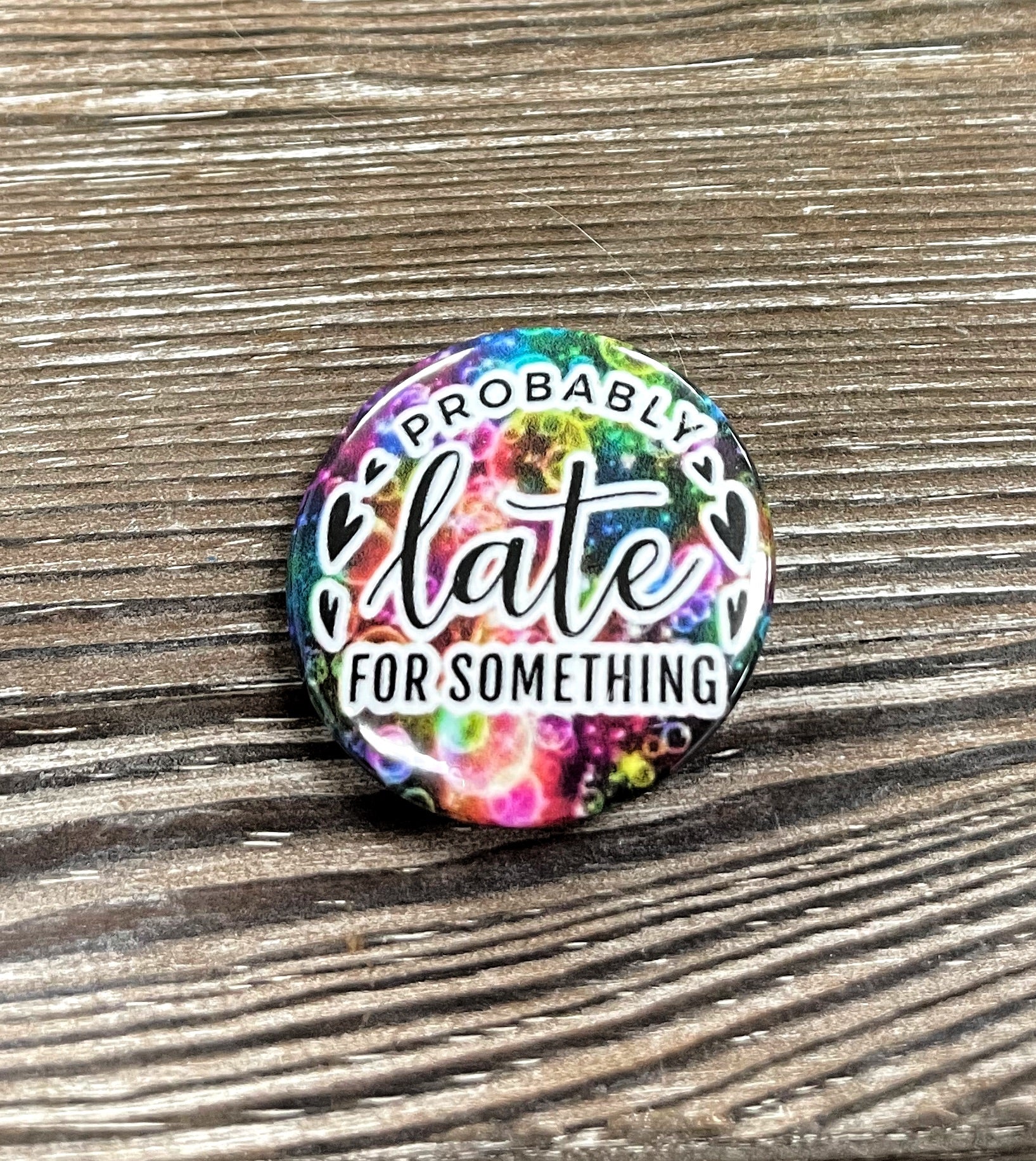 Colorful 1.25-inch graphic art button pin featuring the phrase 'Probably Late for Something', perfect for personal expression.