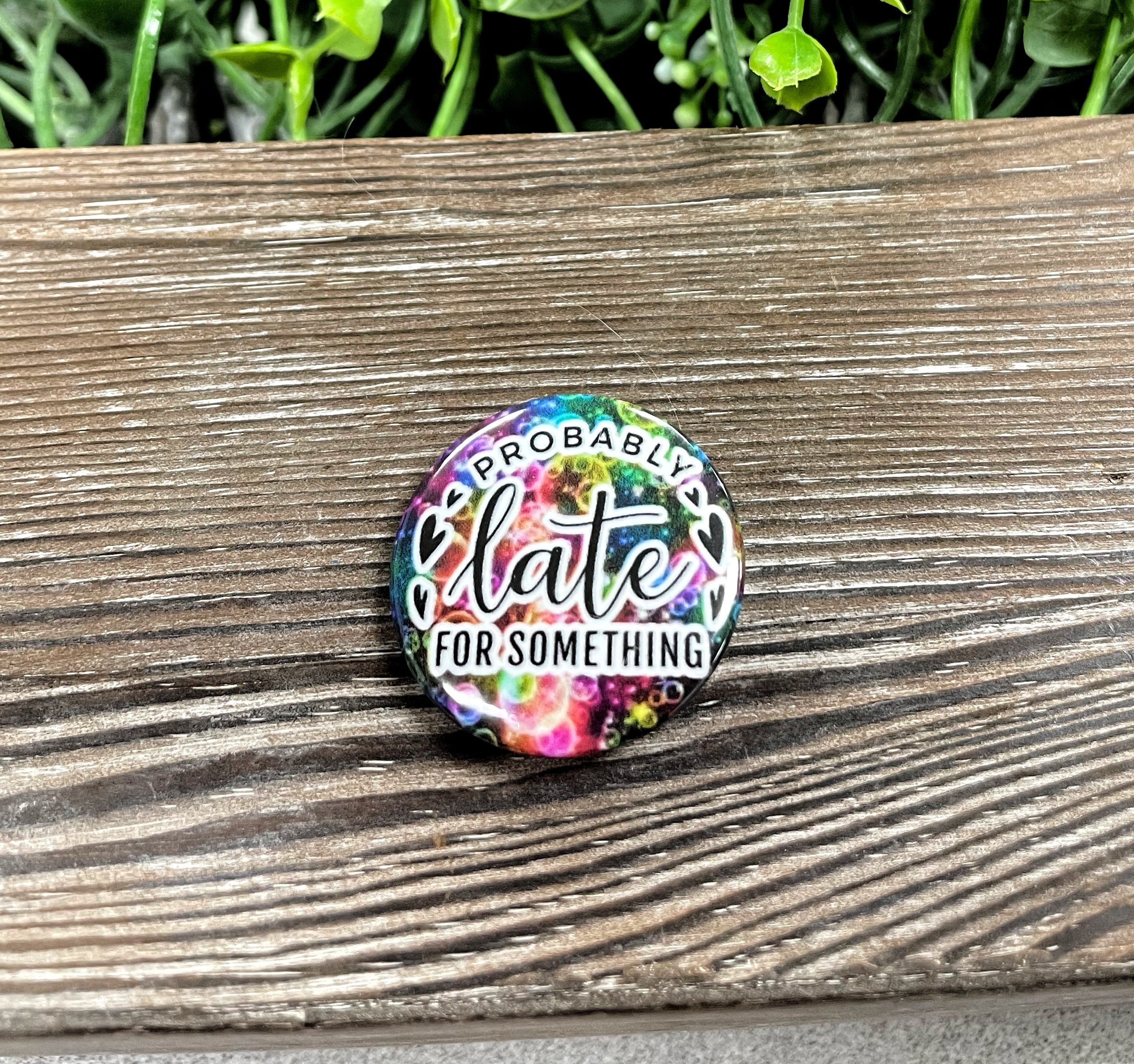 Colorful 1.25-inch graphic art button pin featuring the phrase 'Probably Late for Something', perfect for personal expression.