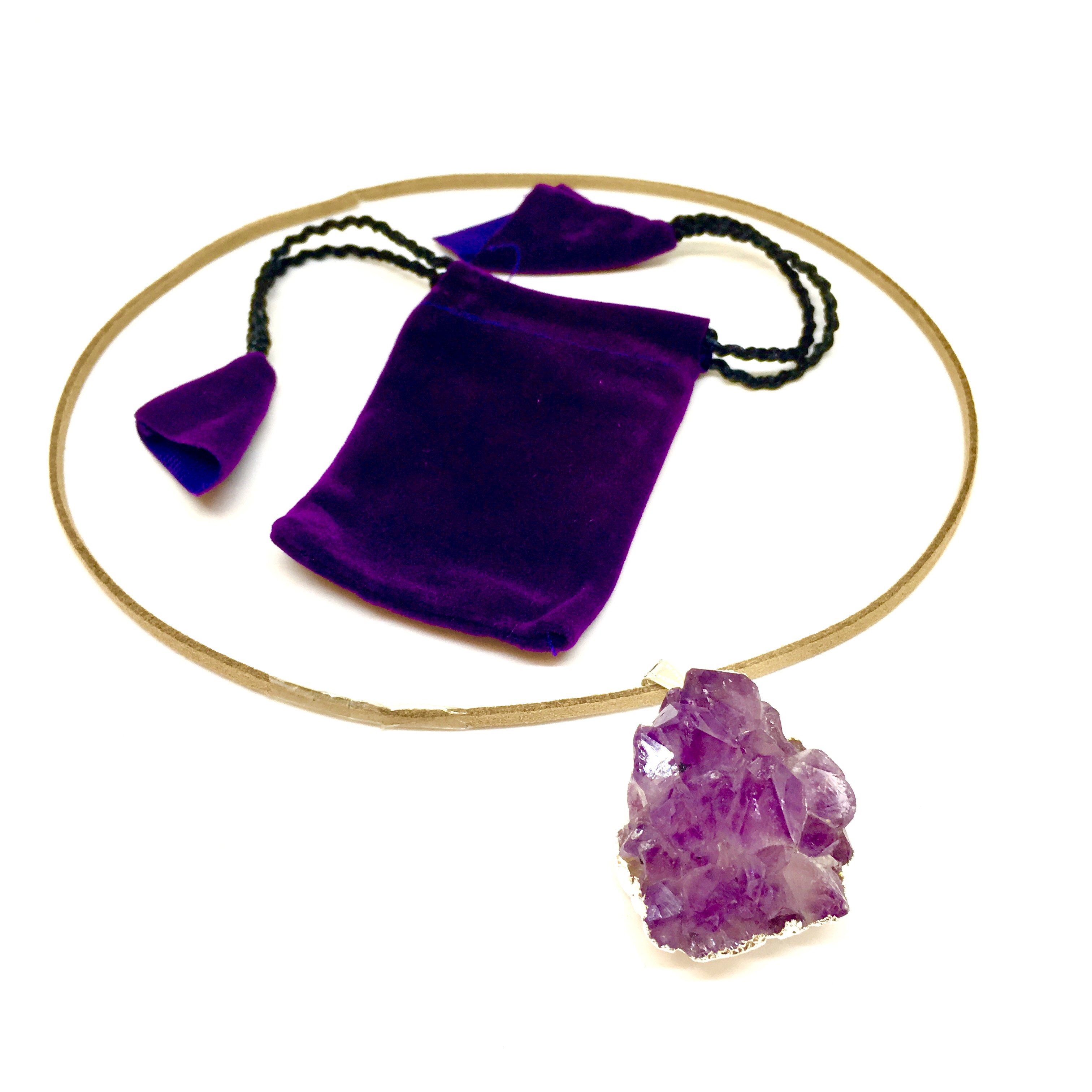 A stunning Purple Amethyst Cluster Pendant showcasing unique purple hues, gold metal plating, and a tan suede necklace.