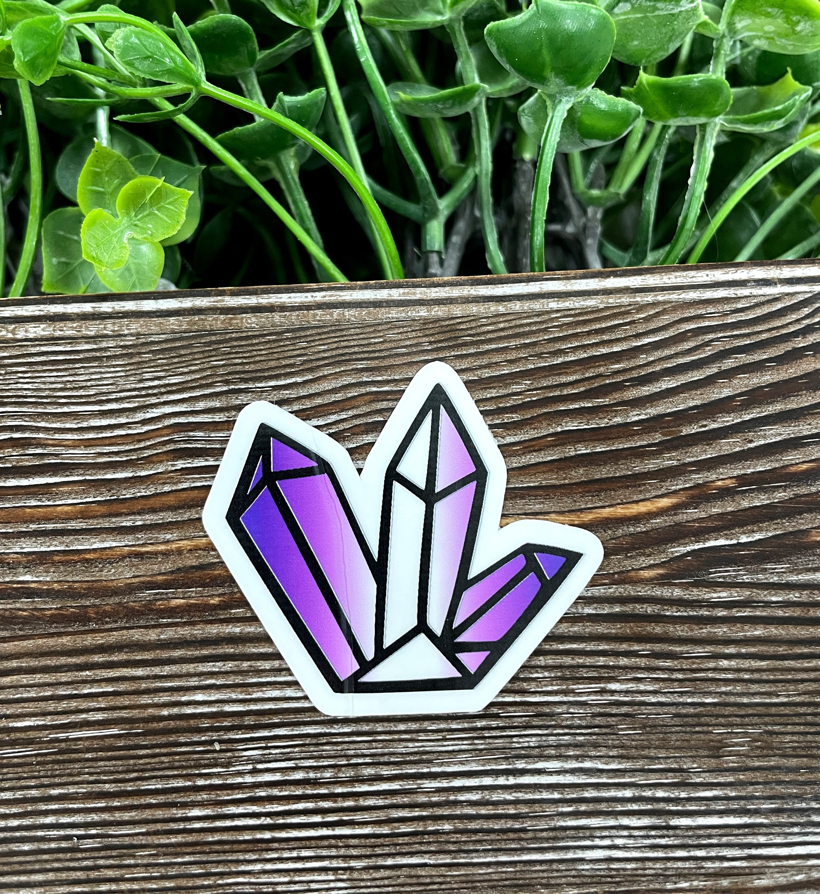 Purple and white crystal cluster graphic art sticker on a smooth surface, showcasing vibrant colors and intricate design.