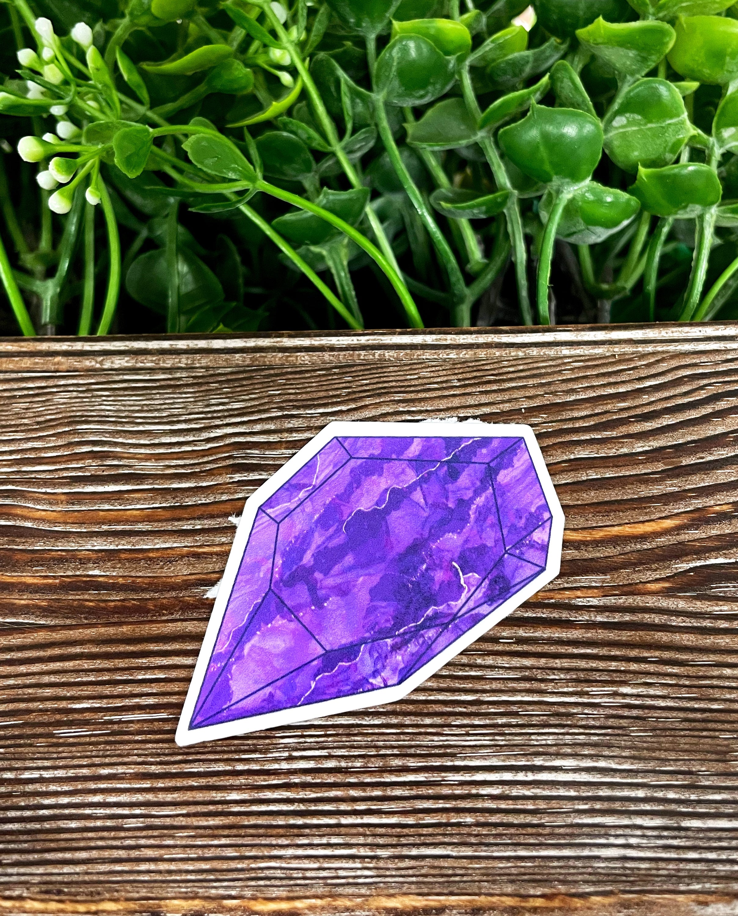 Purple Crystal Gemstone die cut sticker on a smooth surface, showcasing vibrant colors and intricate design.