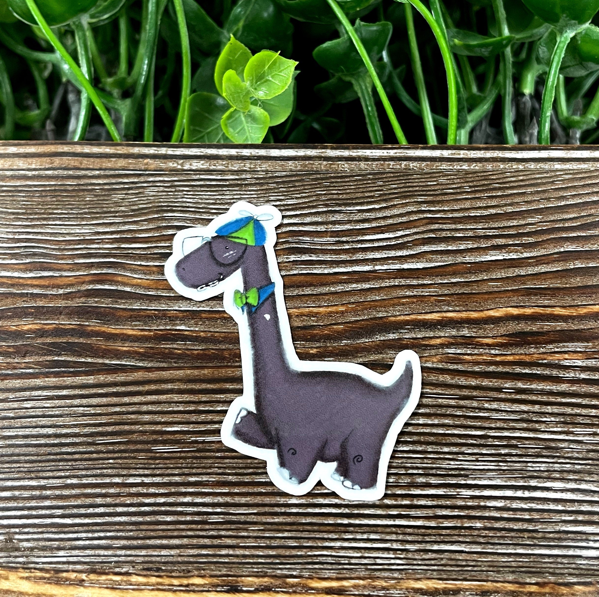 A vibrant School Grey Dinosaur Sticker featuring a playful dinosaur design, perfect for personalizing various items.