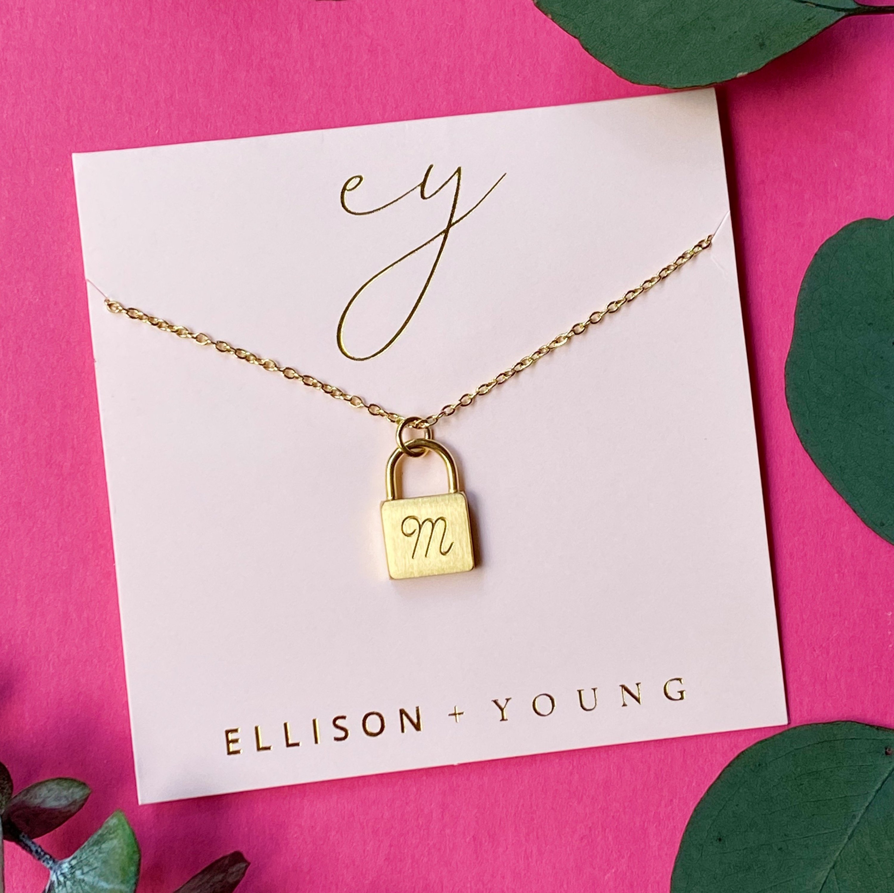 Elegant Scripted Notes Locket Initial Necklace with brushed finish and monogram initial.