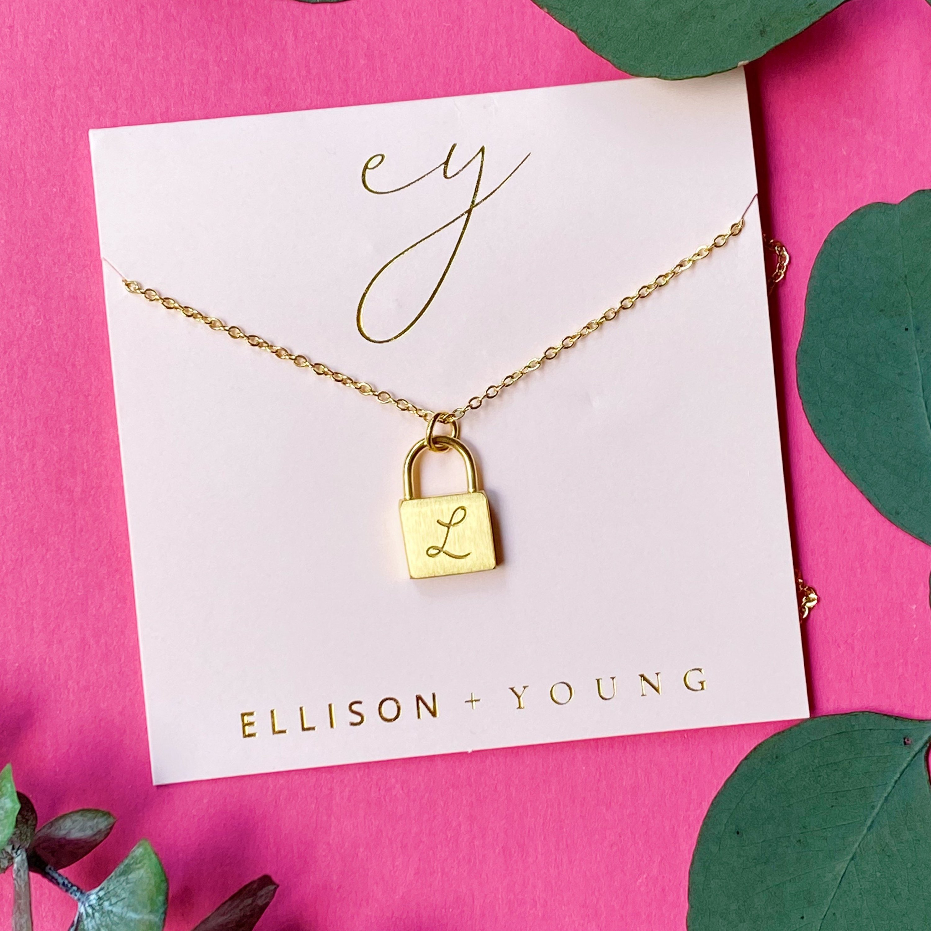 Elegant Scripted Notes Locket Initial Necklace with brushed finish and monogram initial.