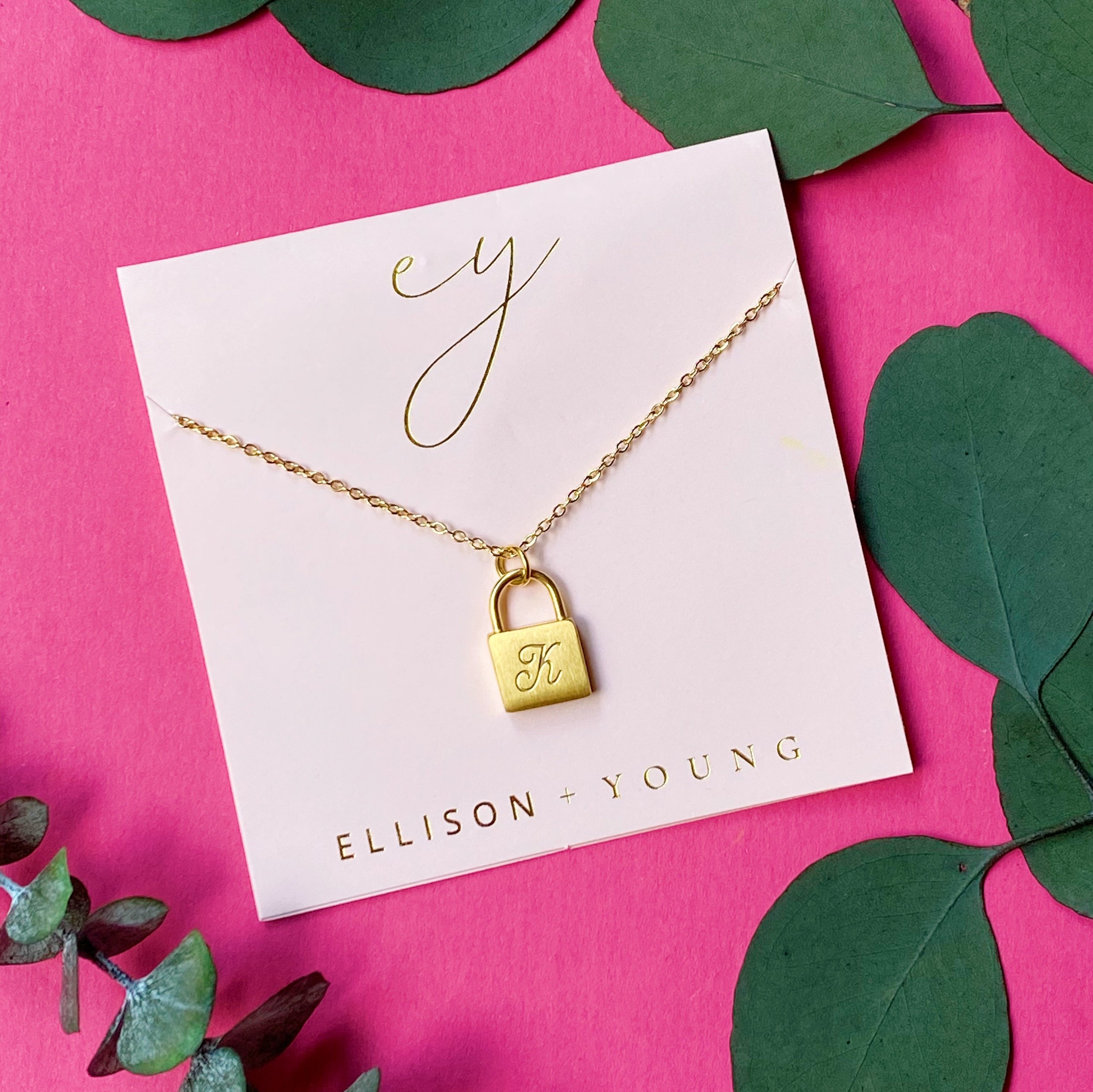 Elegant Scripted Notes Locket Initial Necklace with brushed finish and monogram initial.