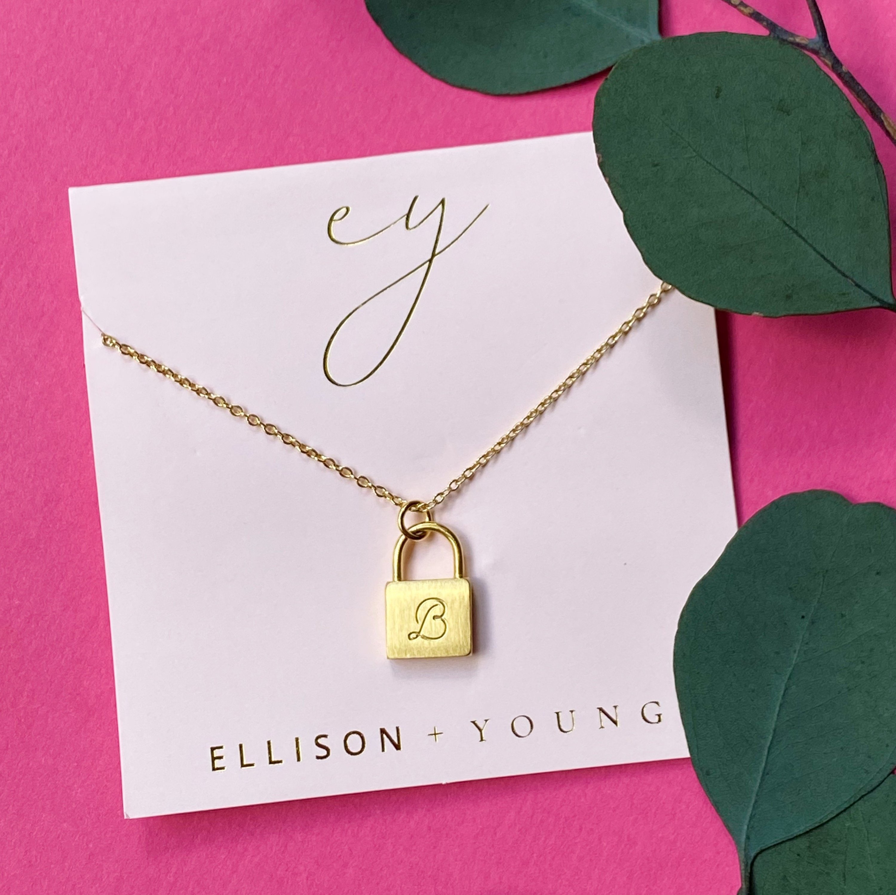 Elegant Scripted Notes Locket Initial Necklace with brushed finish and monogram initial.