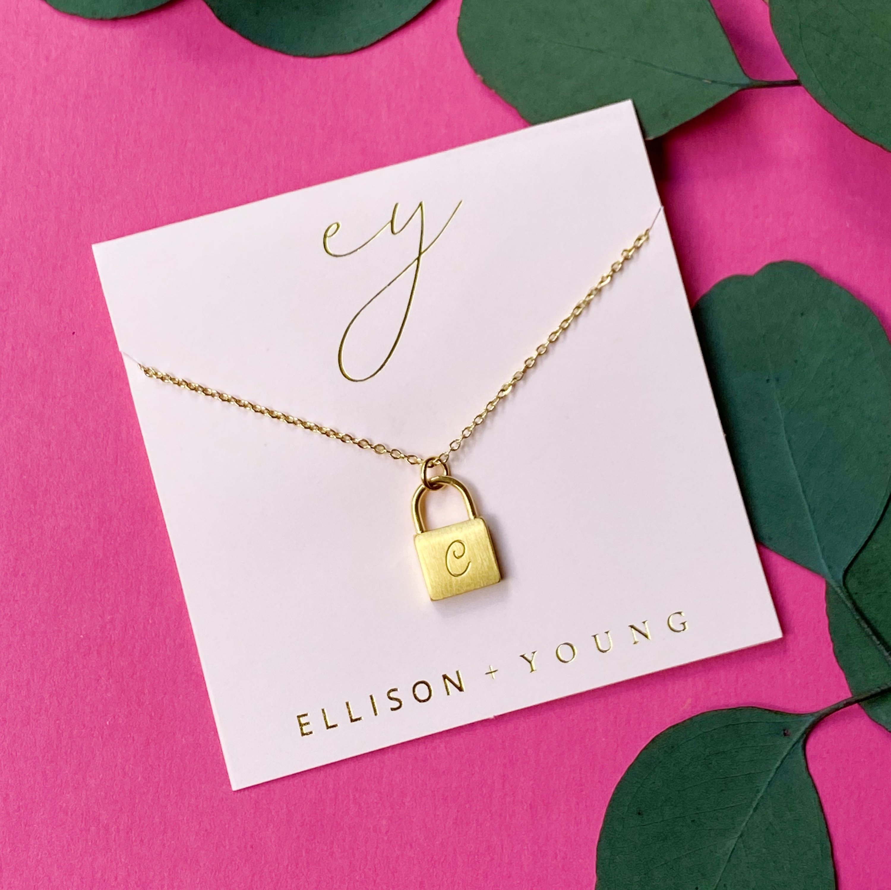 Elegant Scripted Notes Locket Initial Necklace with brushed finish and monogram initial.