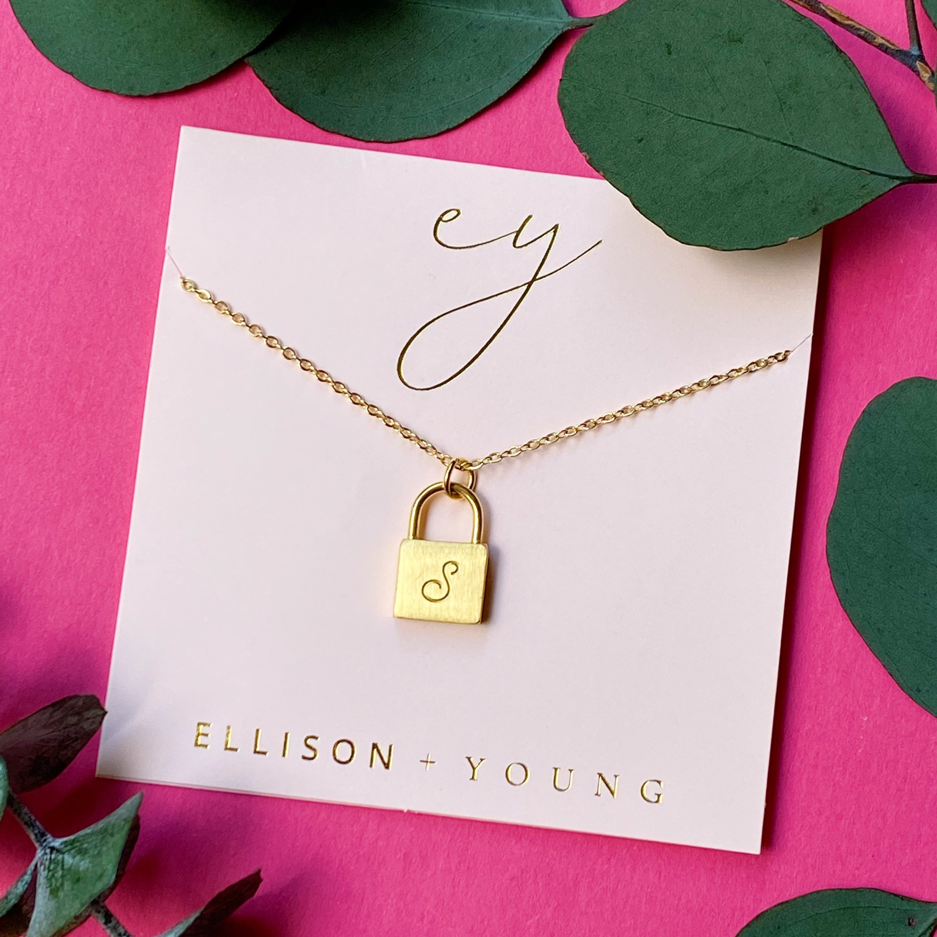 Elegant Scripted Notes Locket Initial Necklace with brushed finish and monogram initial.