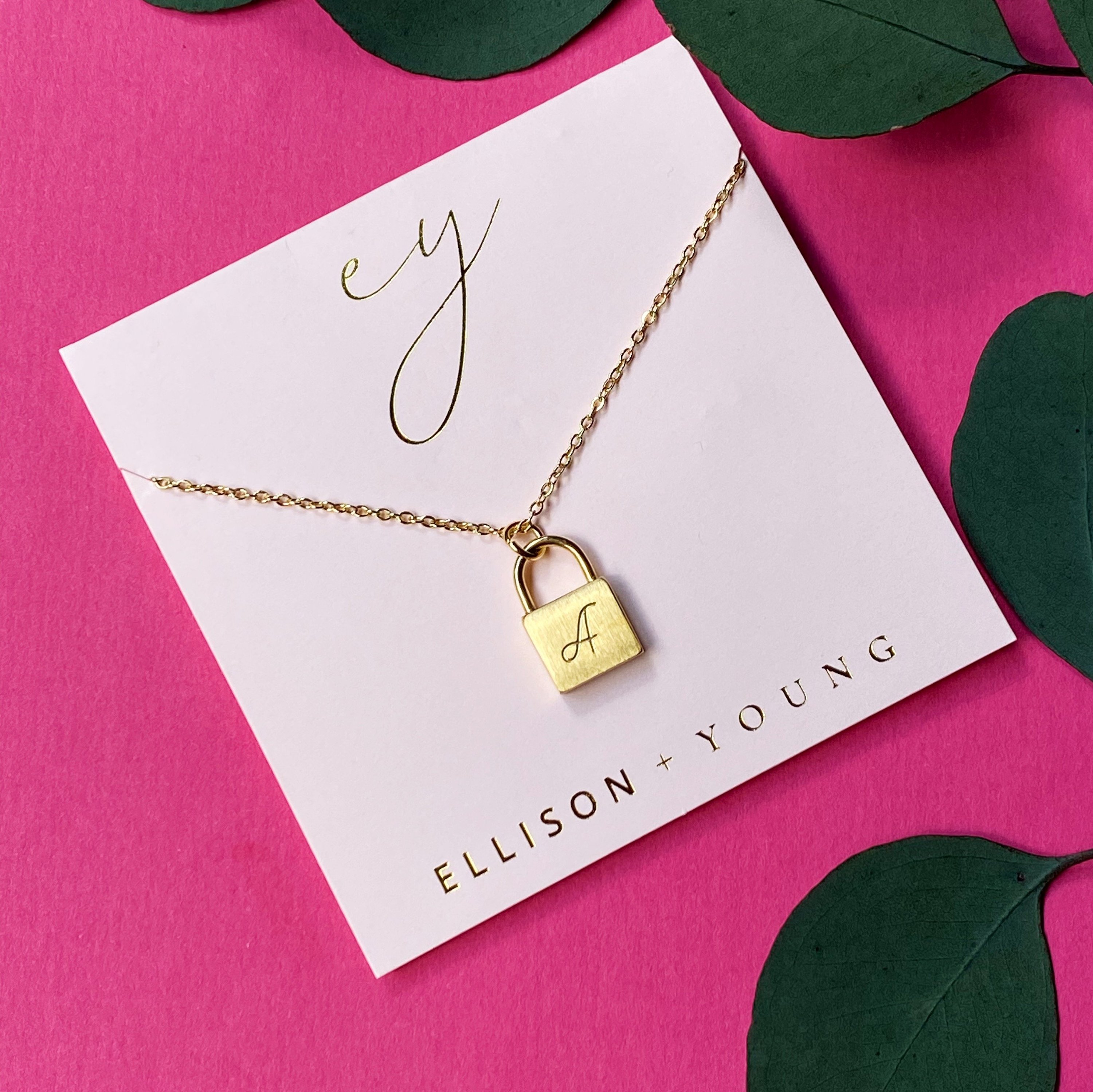 Elegant Scripted Notes Locket Initial Necklace with brushed finish and monogram initial.