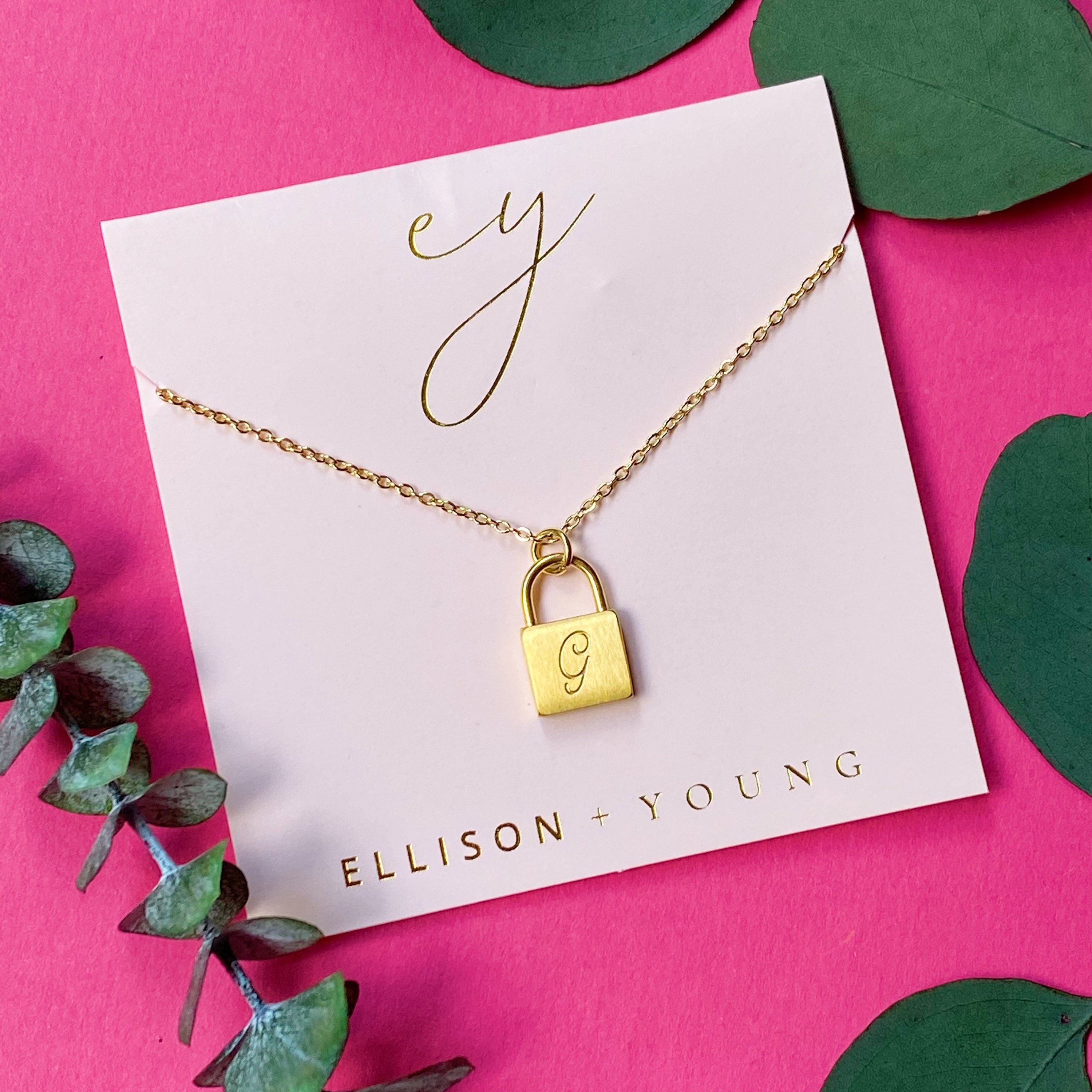 Elegant Scripted Notes Locket Initial Necklace with brushed finish and monogram initial.